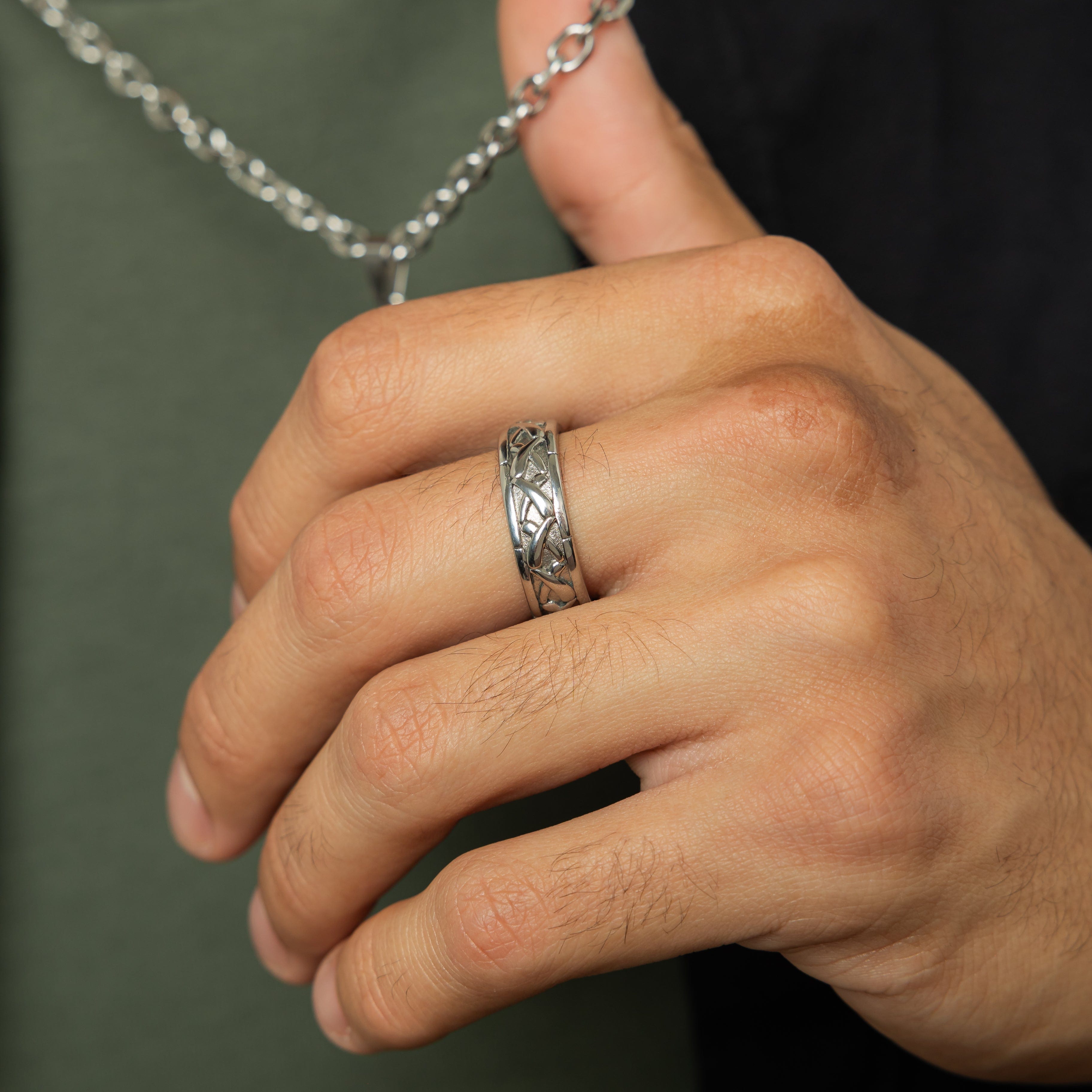 Lifestyle image of a man wearing the Emblem of Legacy Ring at a social gathering, representing modern style.