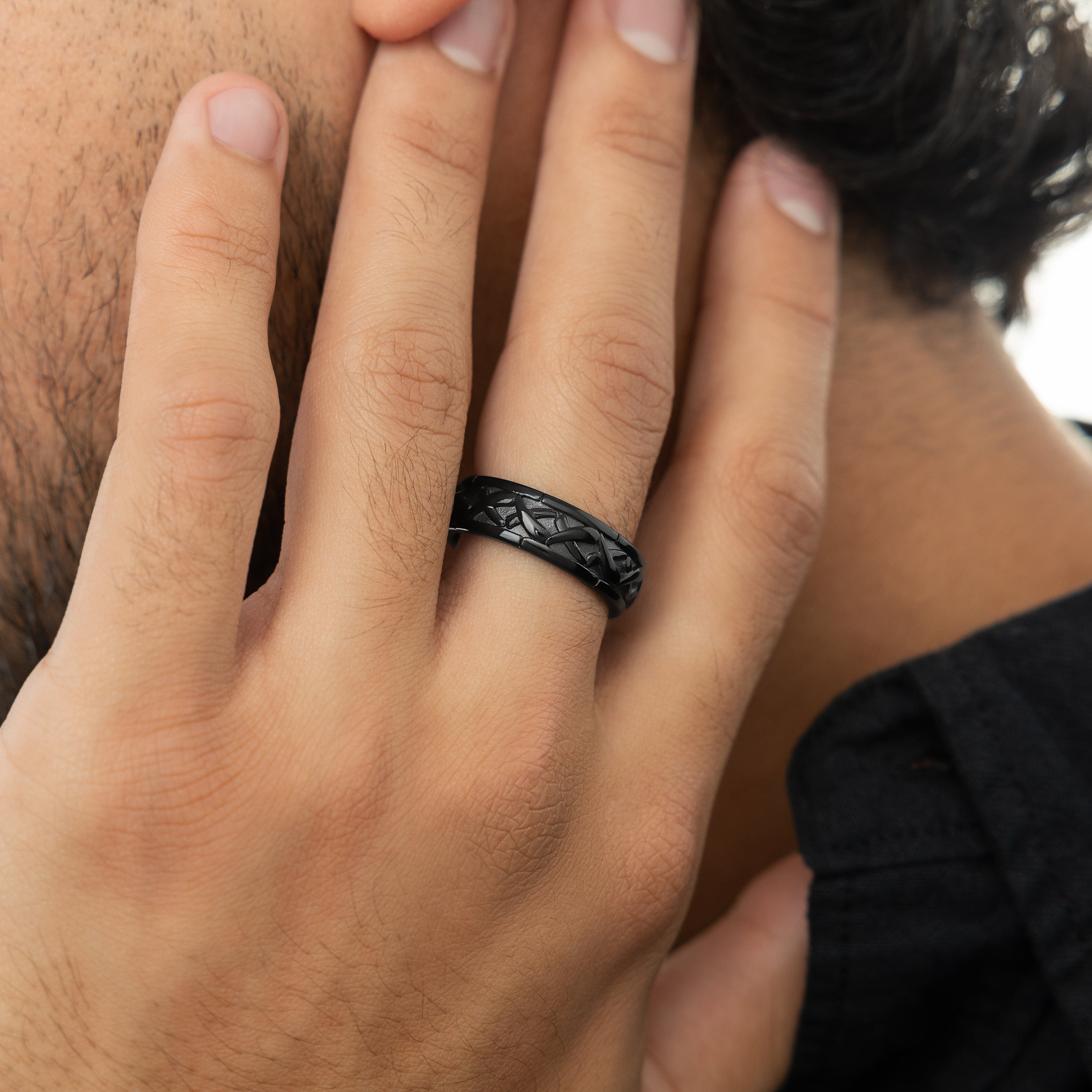 Lifestyle image of a man wearing the Emblem of Legacy Ring at a social gathering, representing modern style.