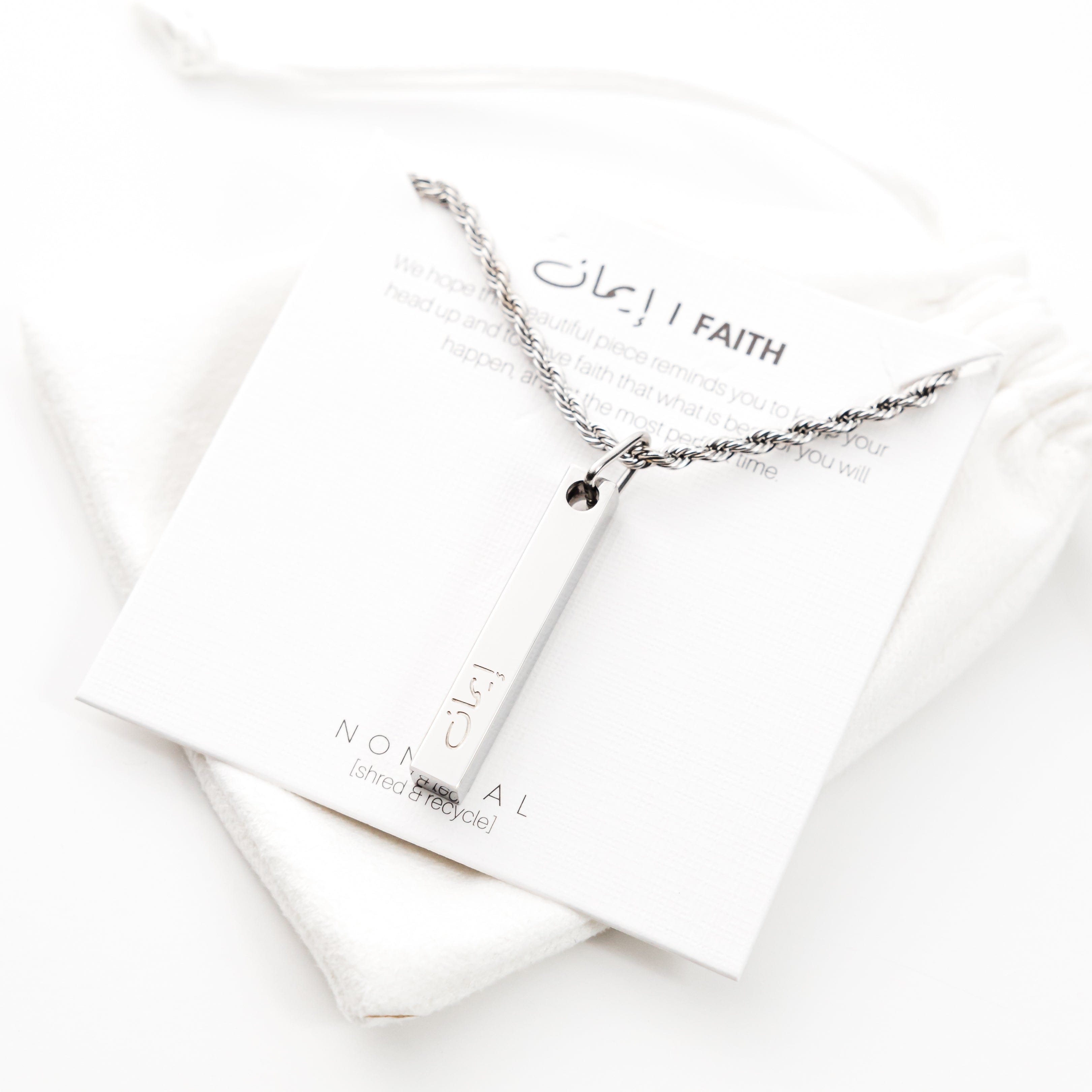 Mens faith necklace with warranty showcased in a velvet pouch.