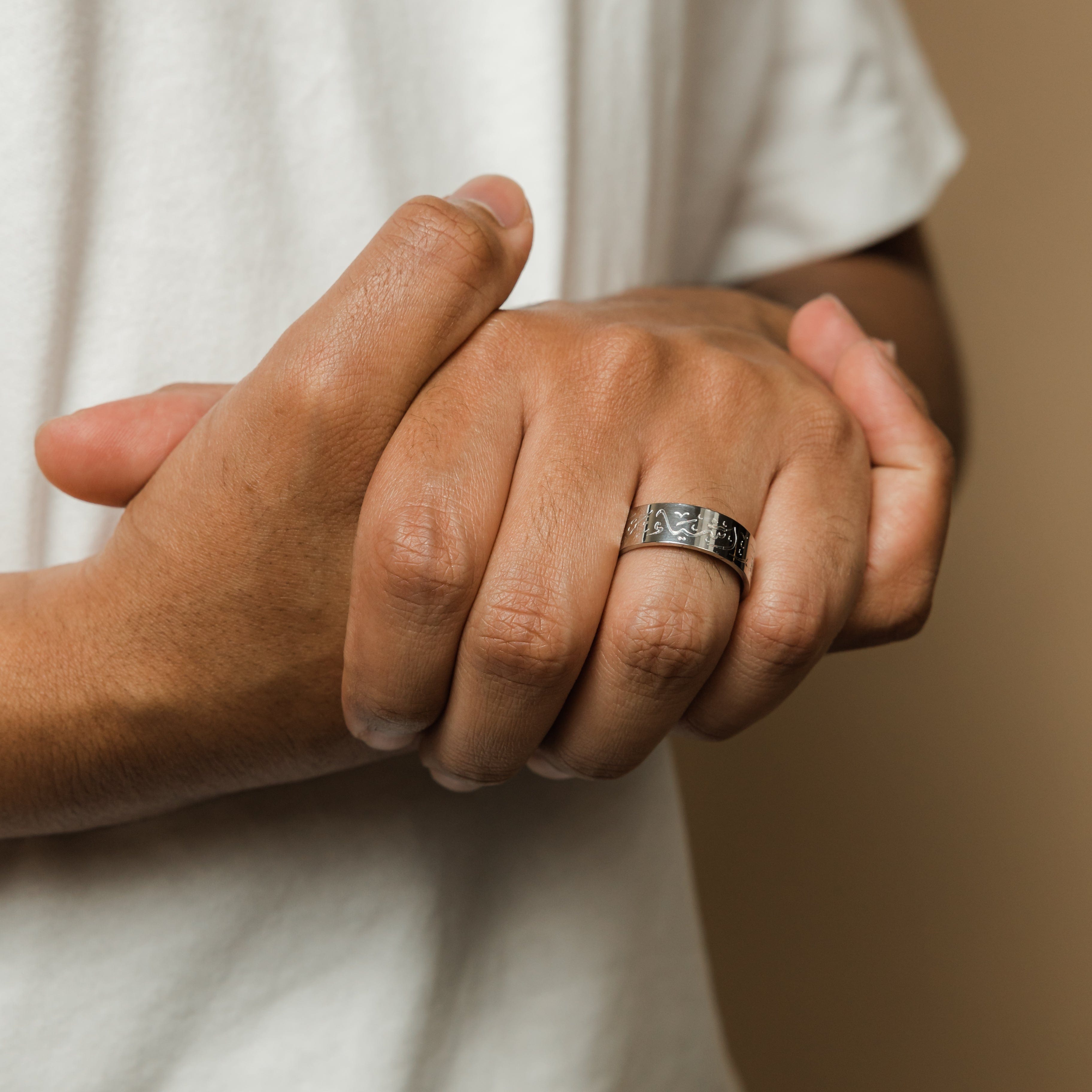 Patience Arabic calligraphy ring displayed on a hand, highlighting its stylish look for everyday wear.