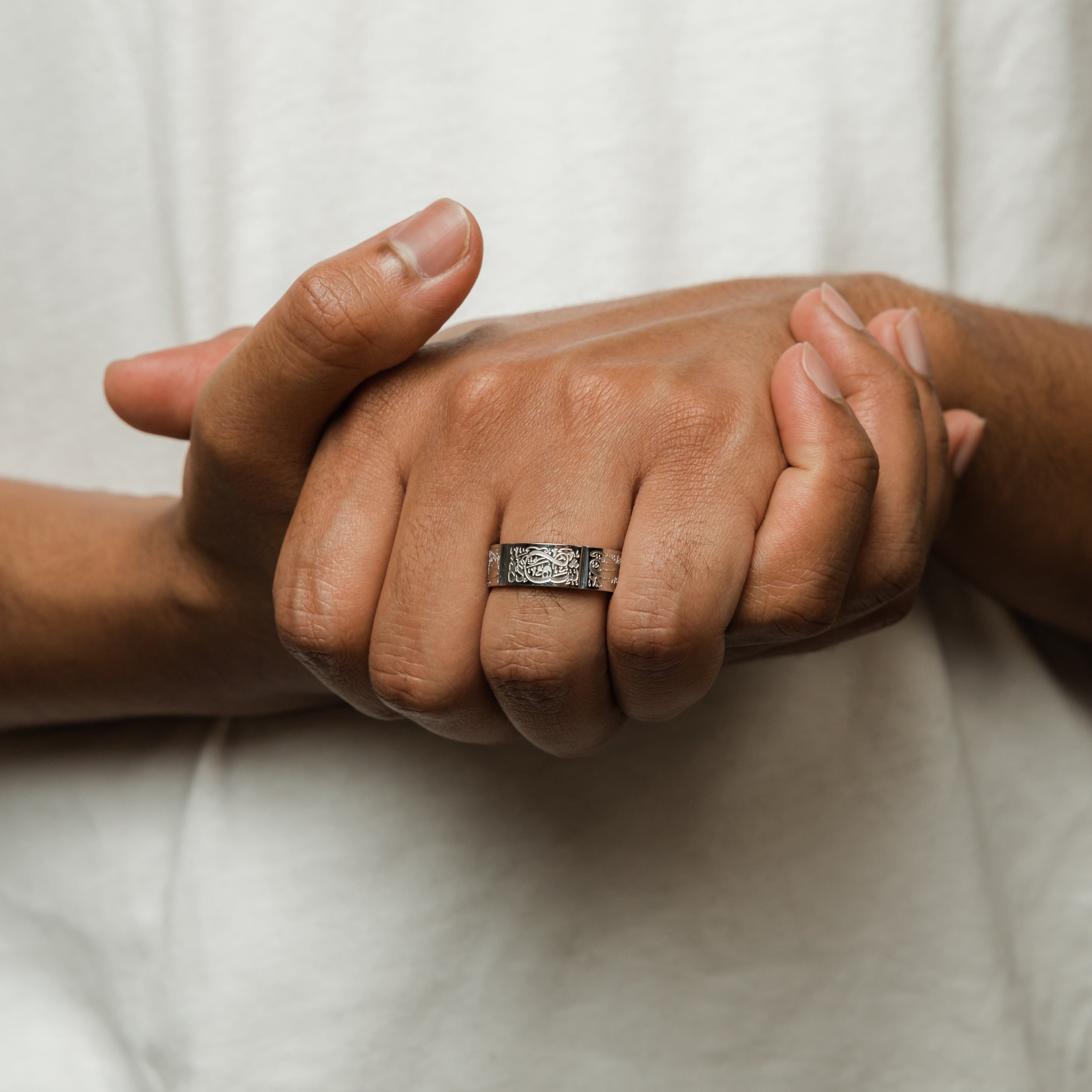 Man wearing the Five Pillars Islamic Ring, showcasing its elegant design.