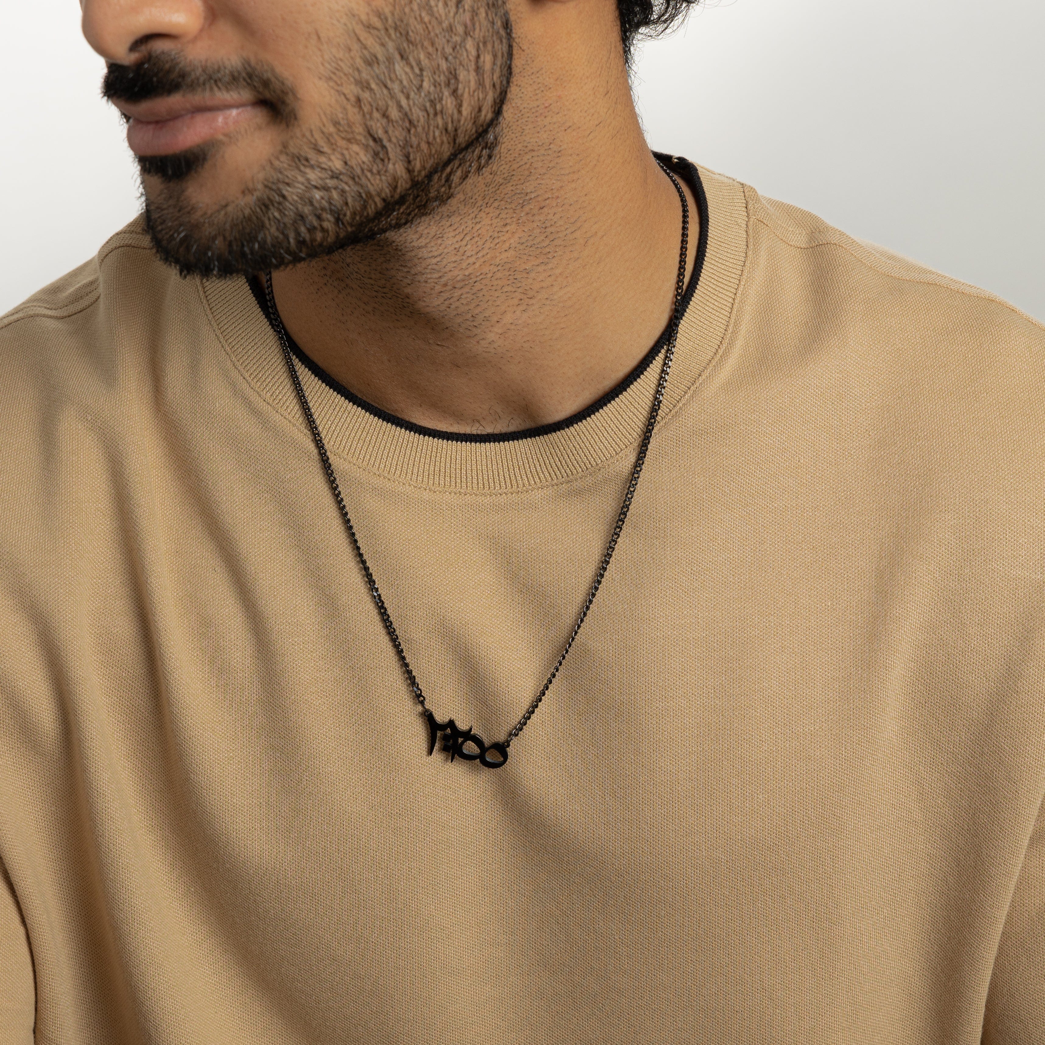 Close-up of Ayatul Kursi pendant necklace showcasing intricate Arabic calligraphy.