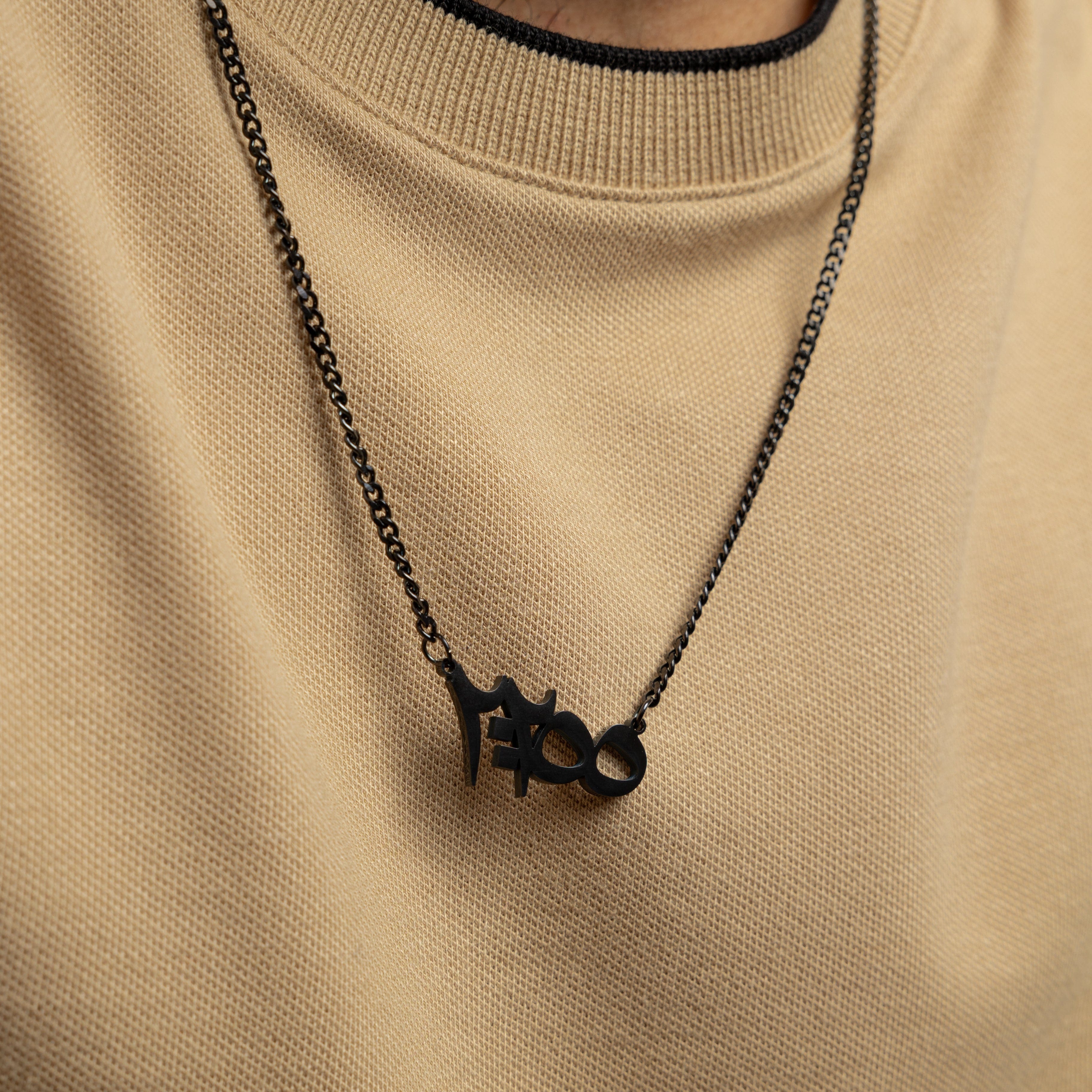 Close-up of Ayatul Kursi pendant necklace showcasing intricate Arabic calligraphy.