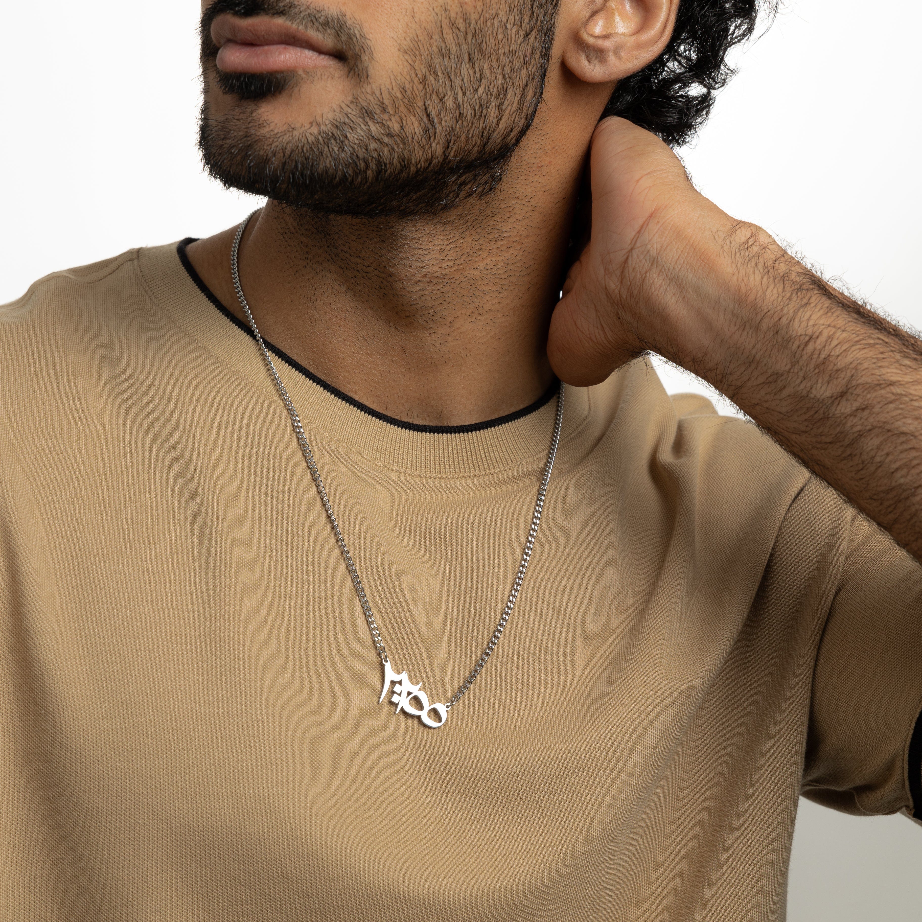 Ayatul Kursi necklace worn by a man, highlighting its stylish design and protective significance.
