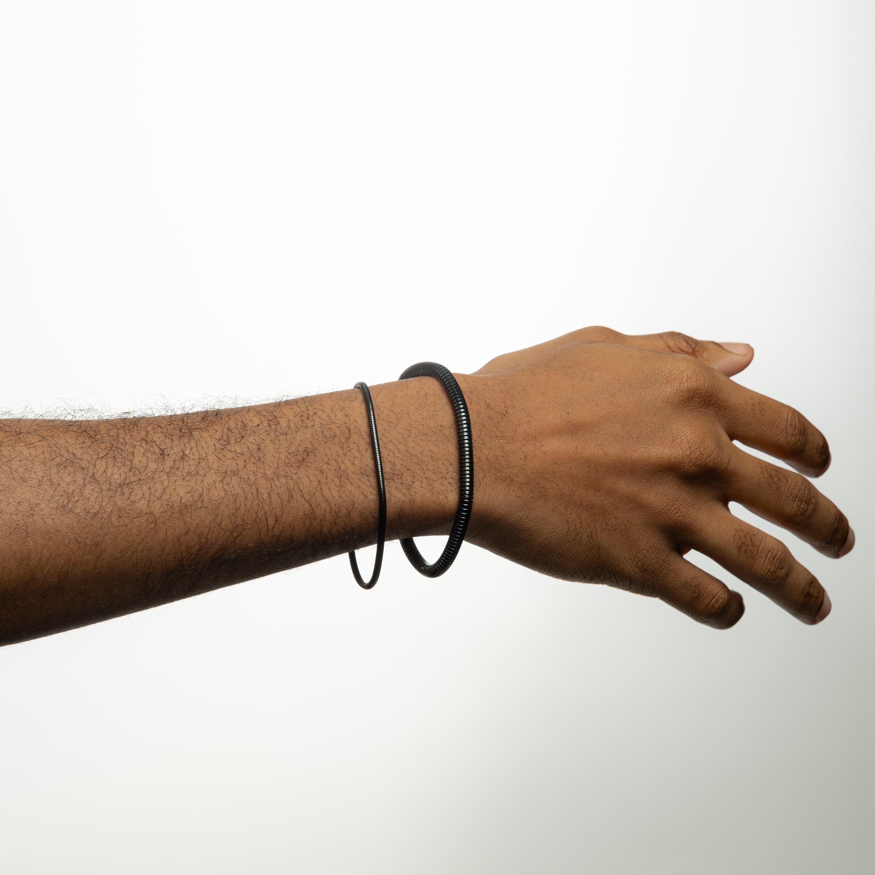 Lifestyle image of a man wearing the Harmony stainless steel bracelet, adding sophistication to his outfit.