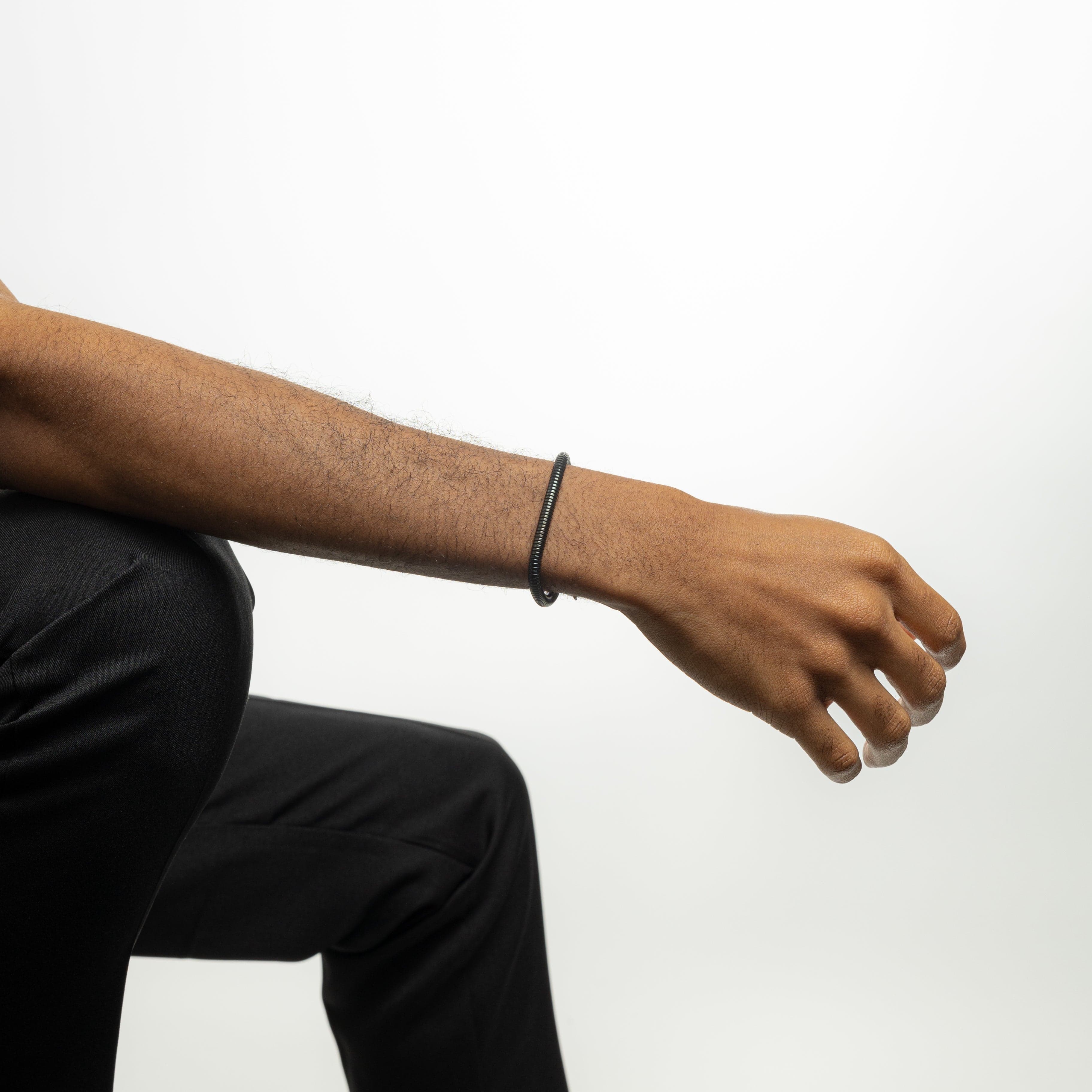 Lifestyle image of a man wearing the Harmony stainless steel bracelet, adding sophistication to his outfit.