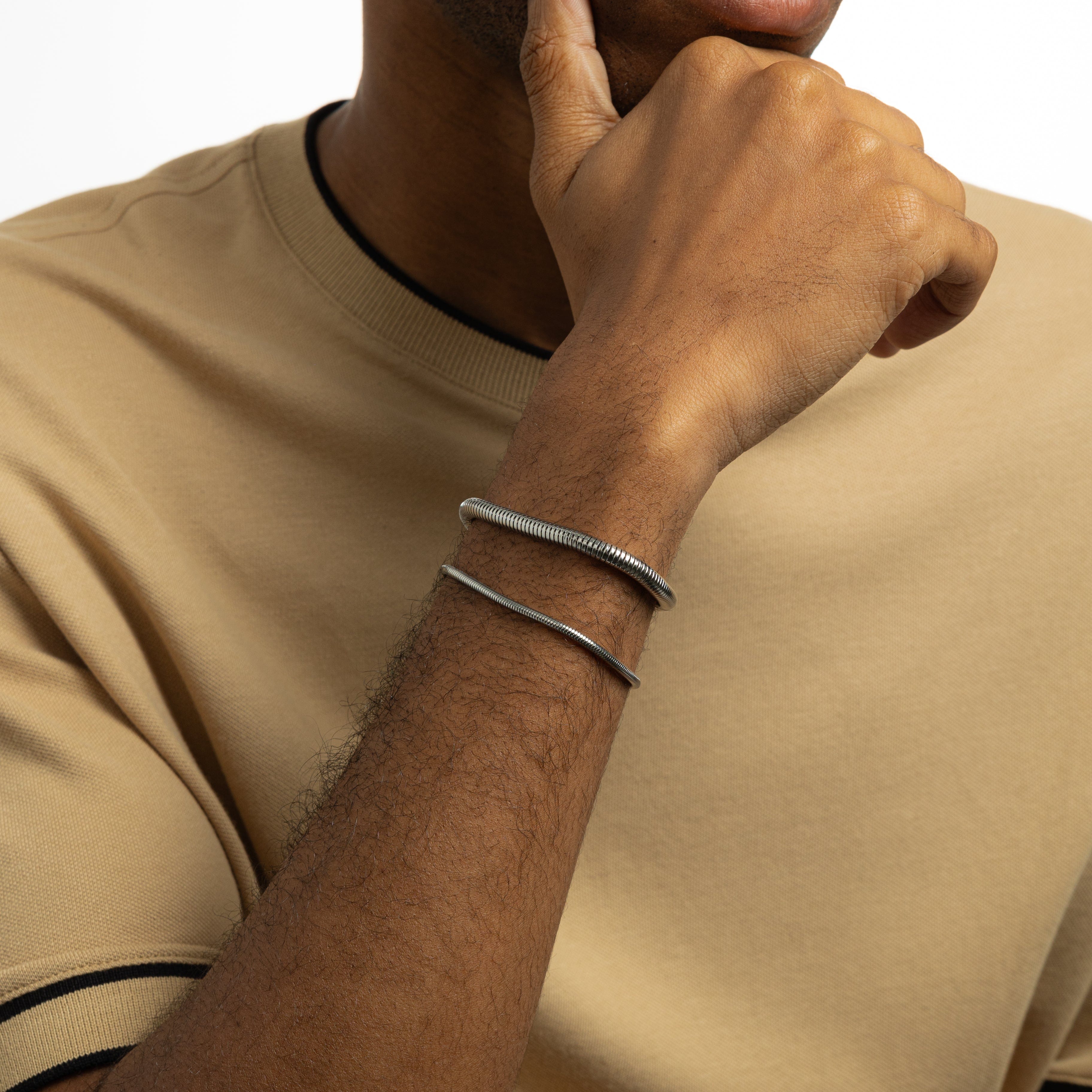 Lifestyle image of a man wearing the Harmony stainless steel bracelet, adding sophistication to his outfit.