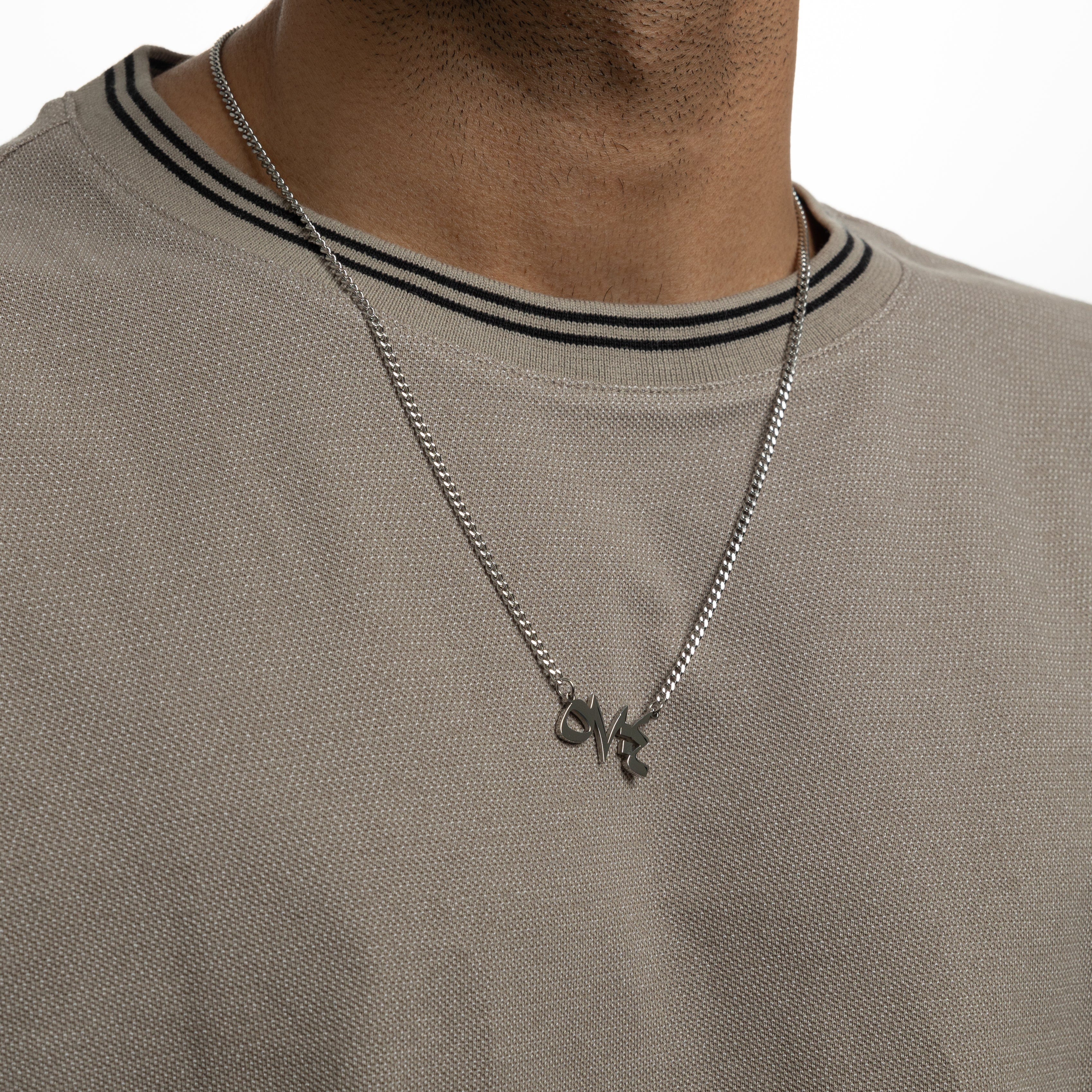 Close-up of Arabic calligraphy pendant with Quran verse for men, highlighting the craftsmanship.