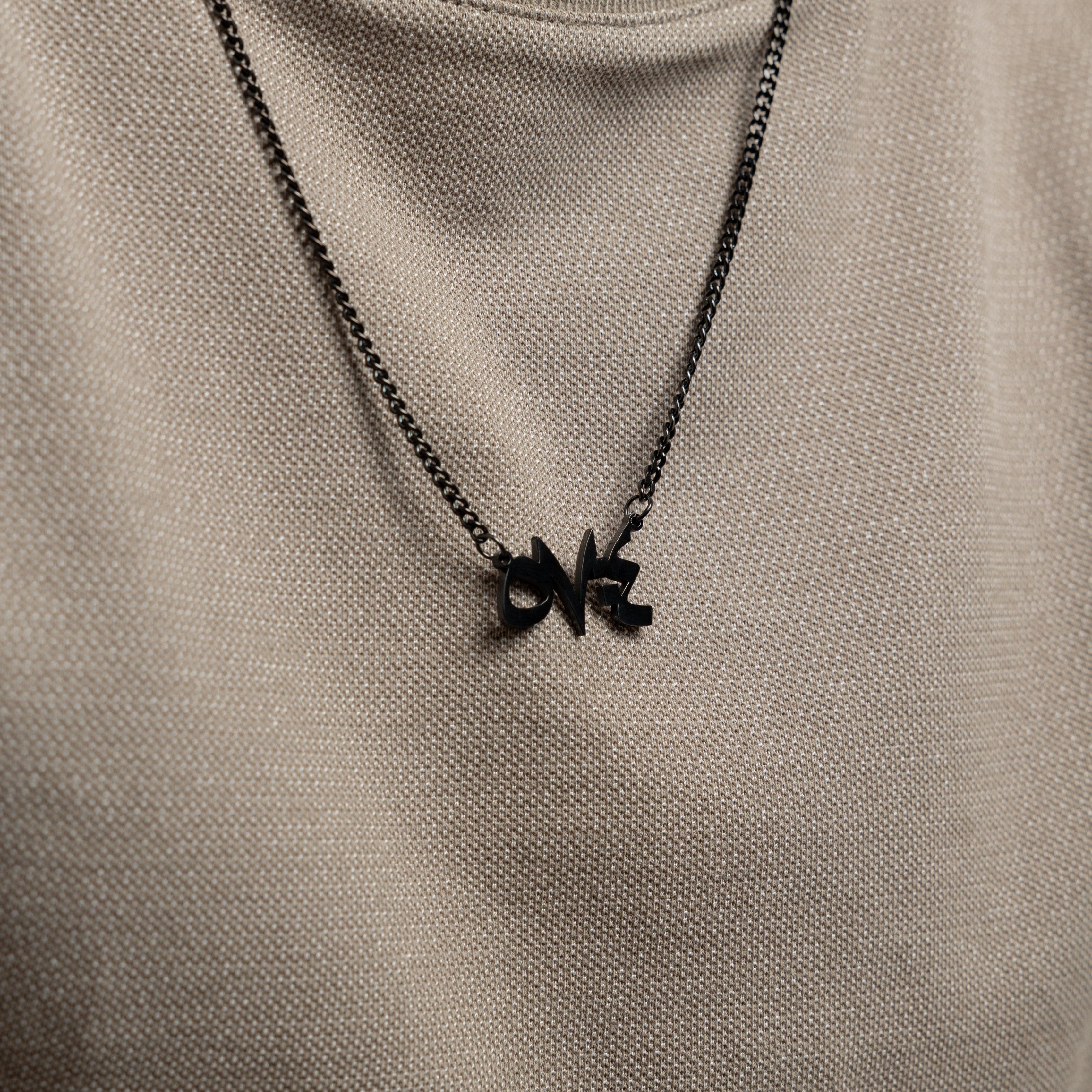 Close-up of Arabic calligraphy pendant with Quran verse for men, highlighting the craftsmanship.