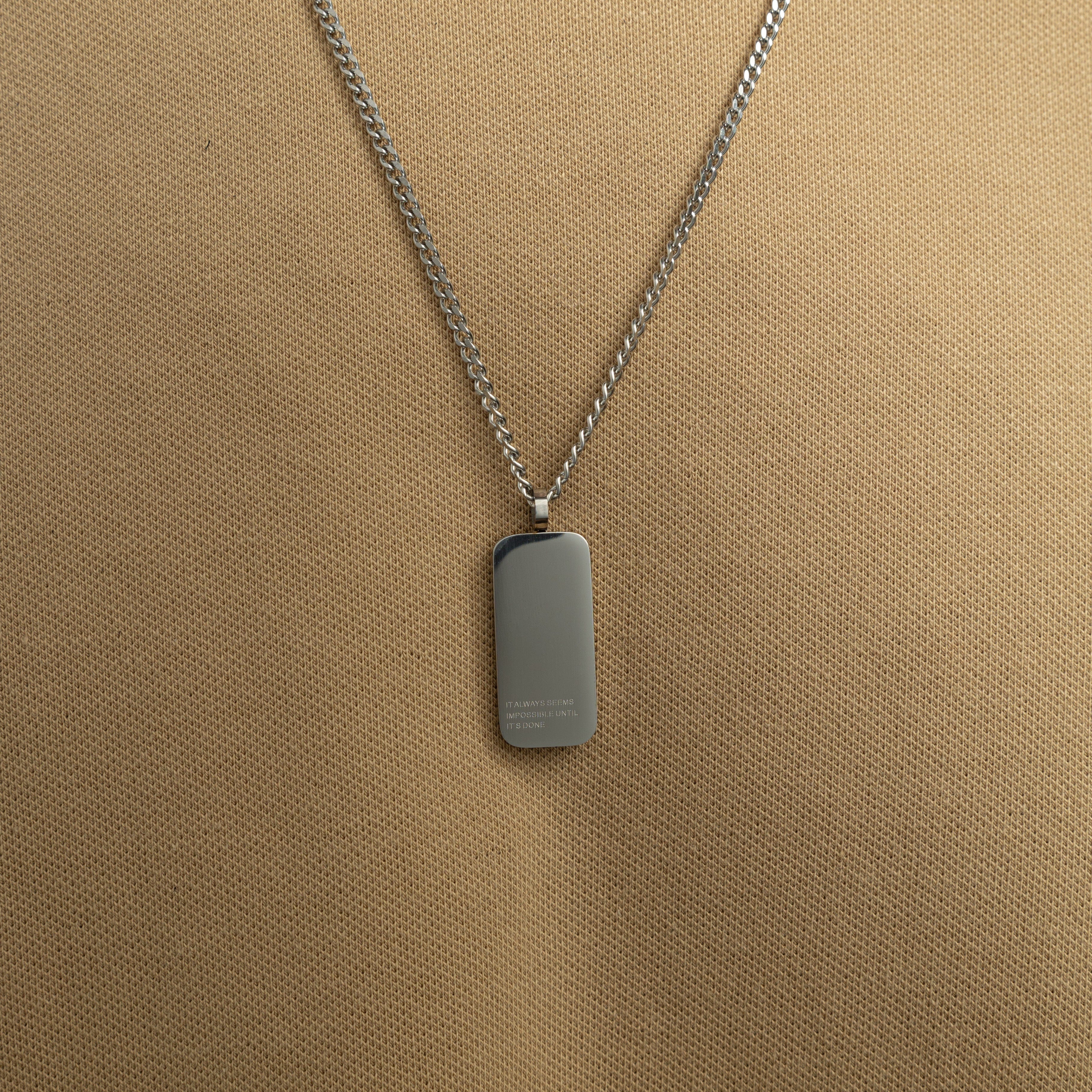 Side view of mens jewelry necklace worn over a white t-shirt