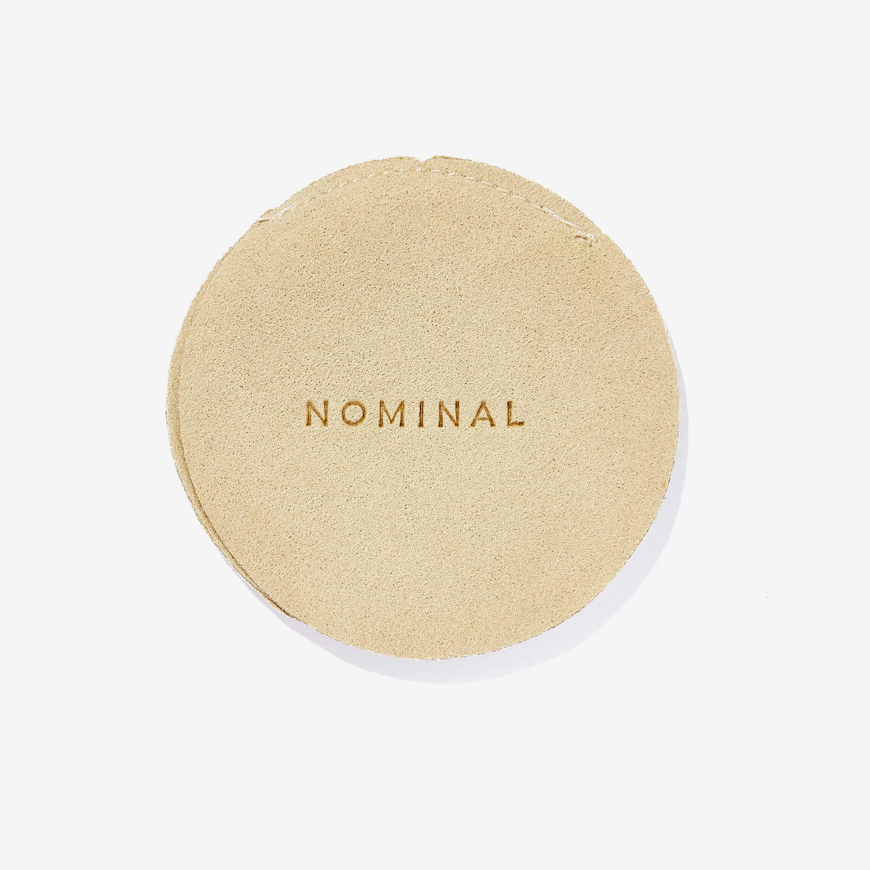 Minimalist mens ring placed beside drawstring pouch for packaging display