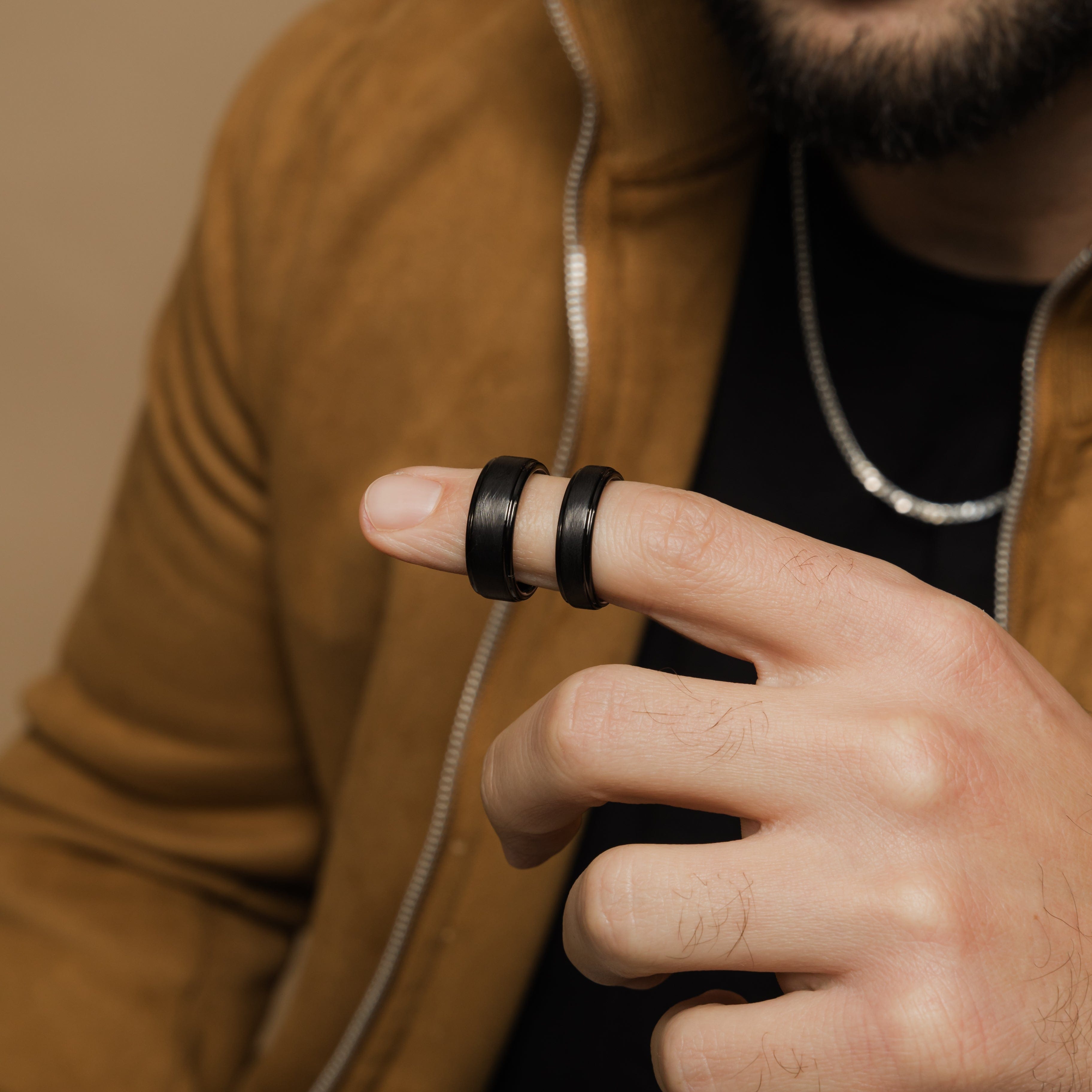 Close-up view of the textured tungsten wedding band, highlighting its rugged finish.