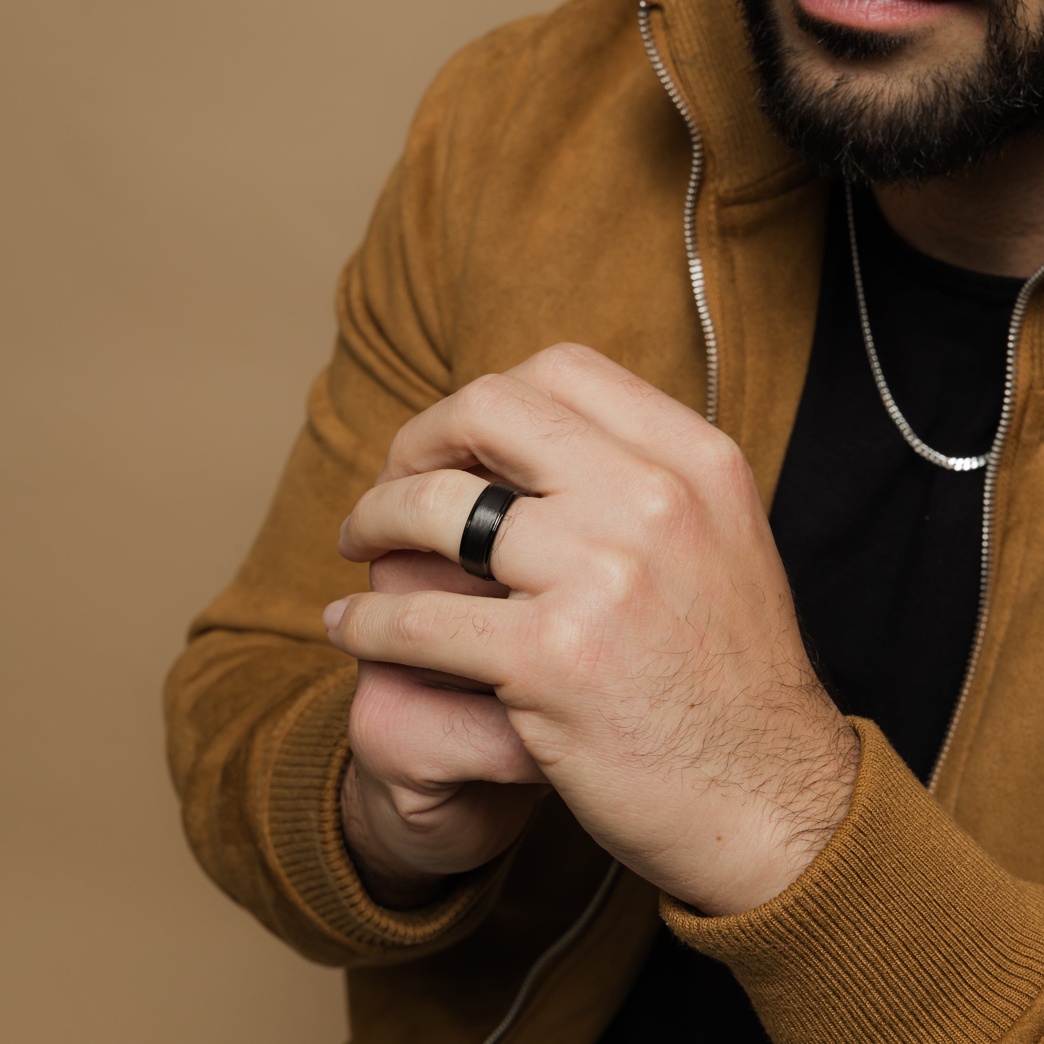 Close-up view of the textured tungsten wedding band, highlighting its rugged finish.