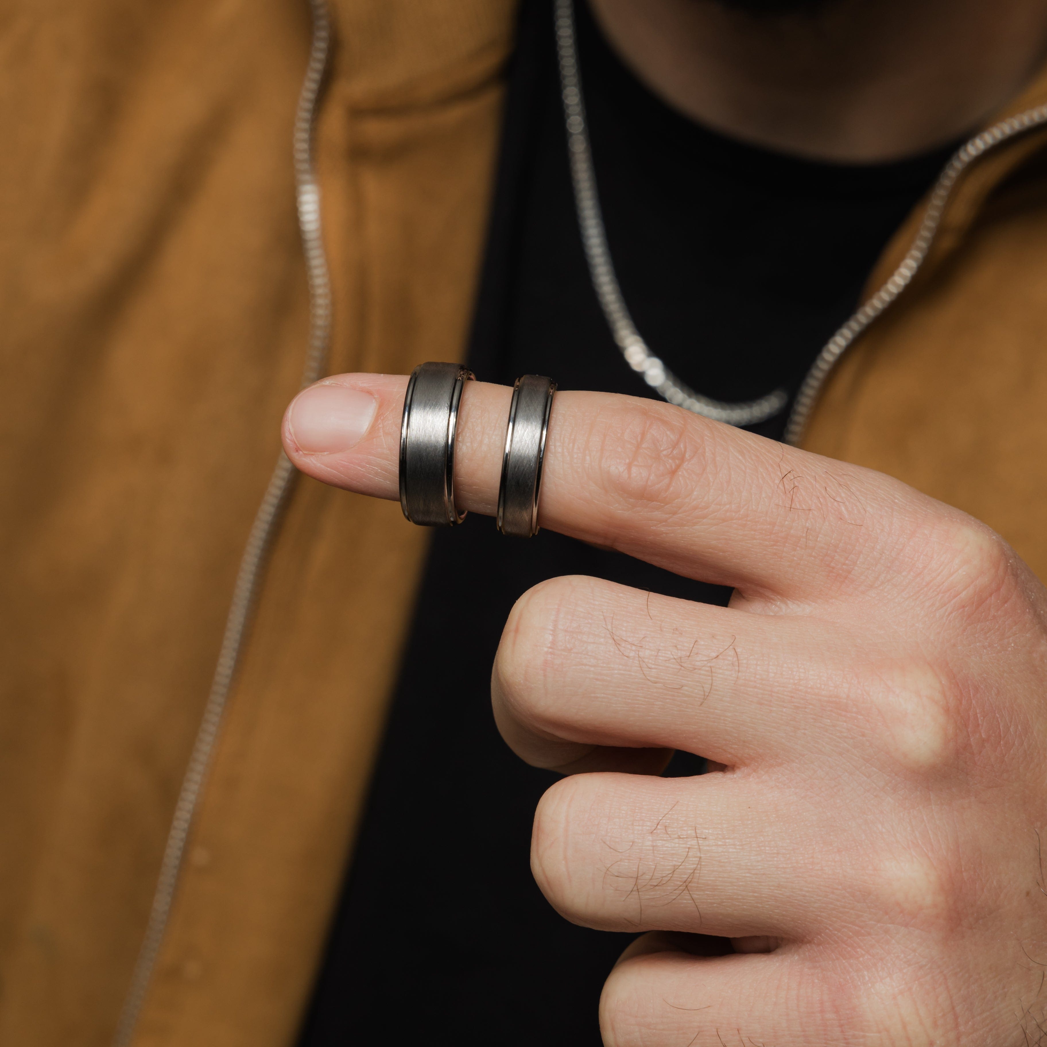 Textured tungsten wedding band worn on a mans hand, demonstrating its daily wear suitability.