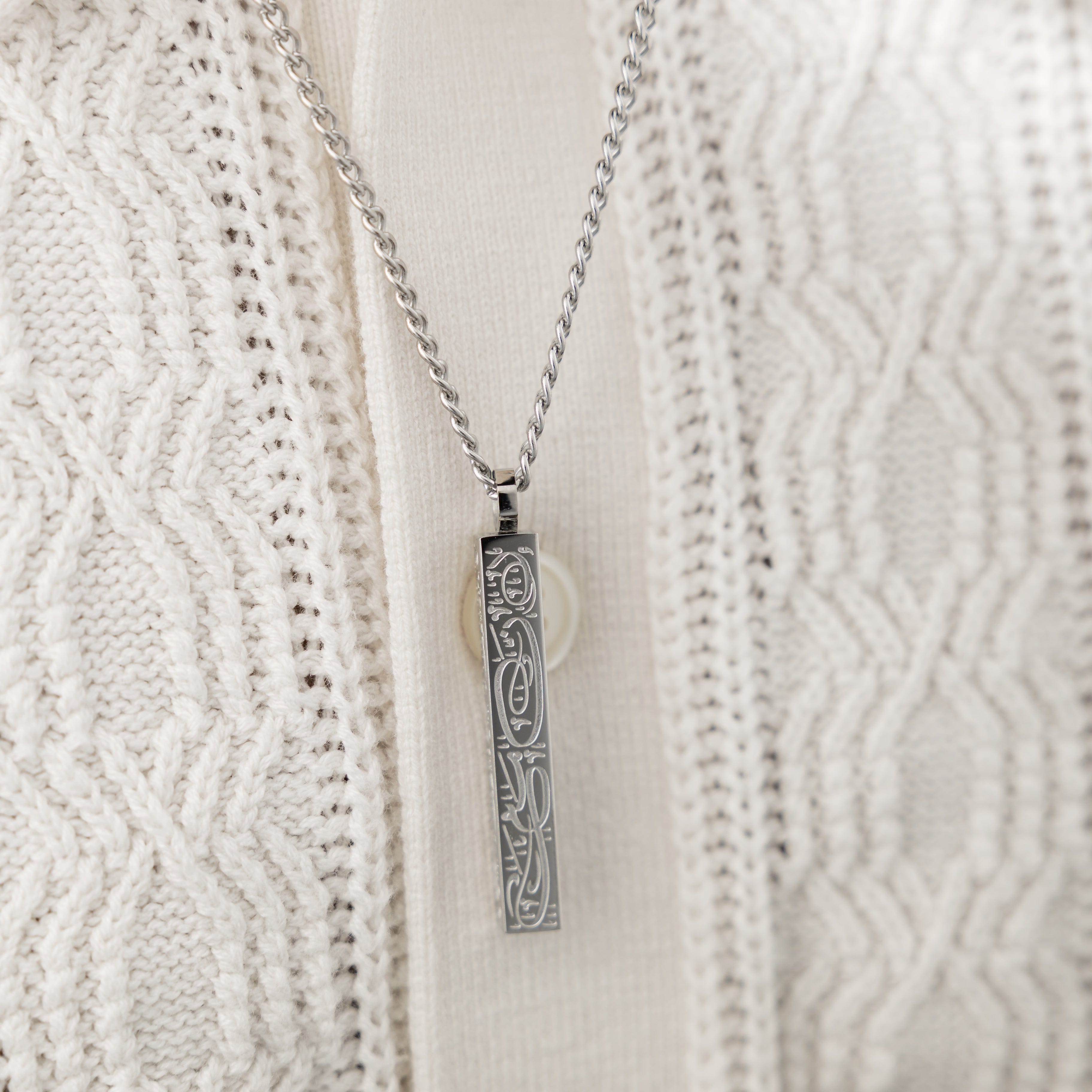 Close-up of the engraved religious necklace for Muslim men, highlighting the intricate design and craftsmanship.