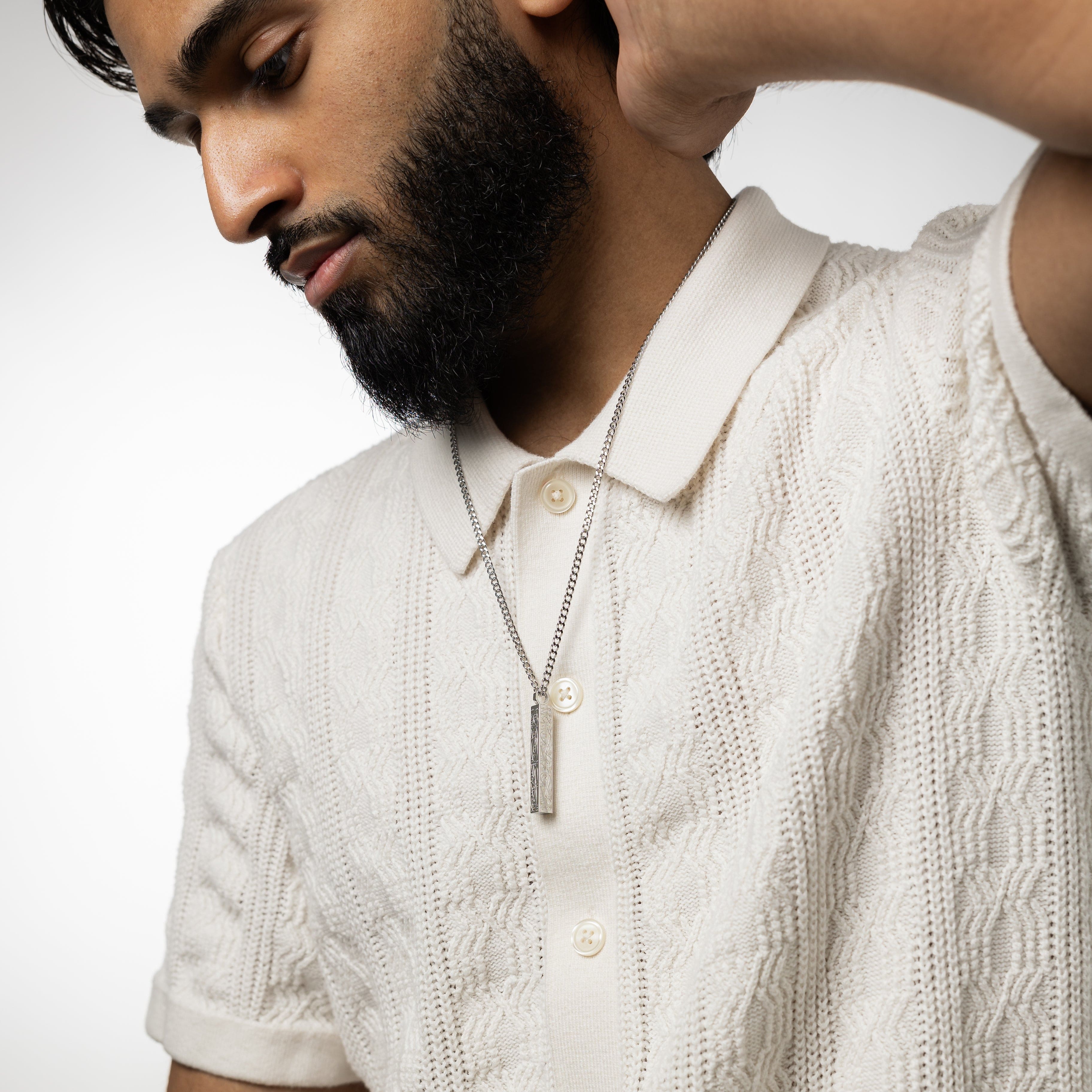 Lifestyle shot of the mens bar necklace worn with casual attire, illustrating its versatility.