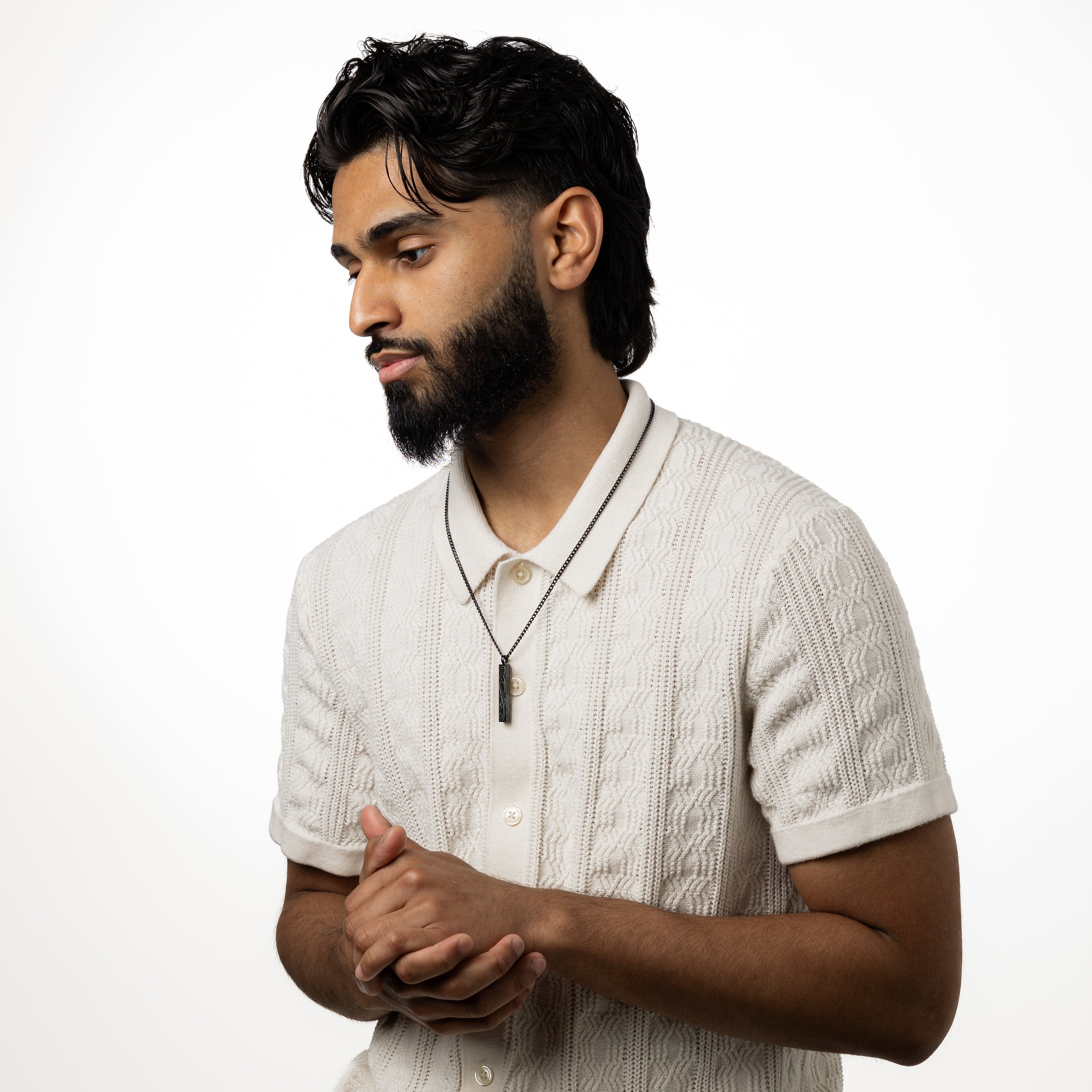 Lifestyle shot of the mens bar necklace worn with casual attire, illustrating its versatility.