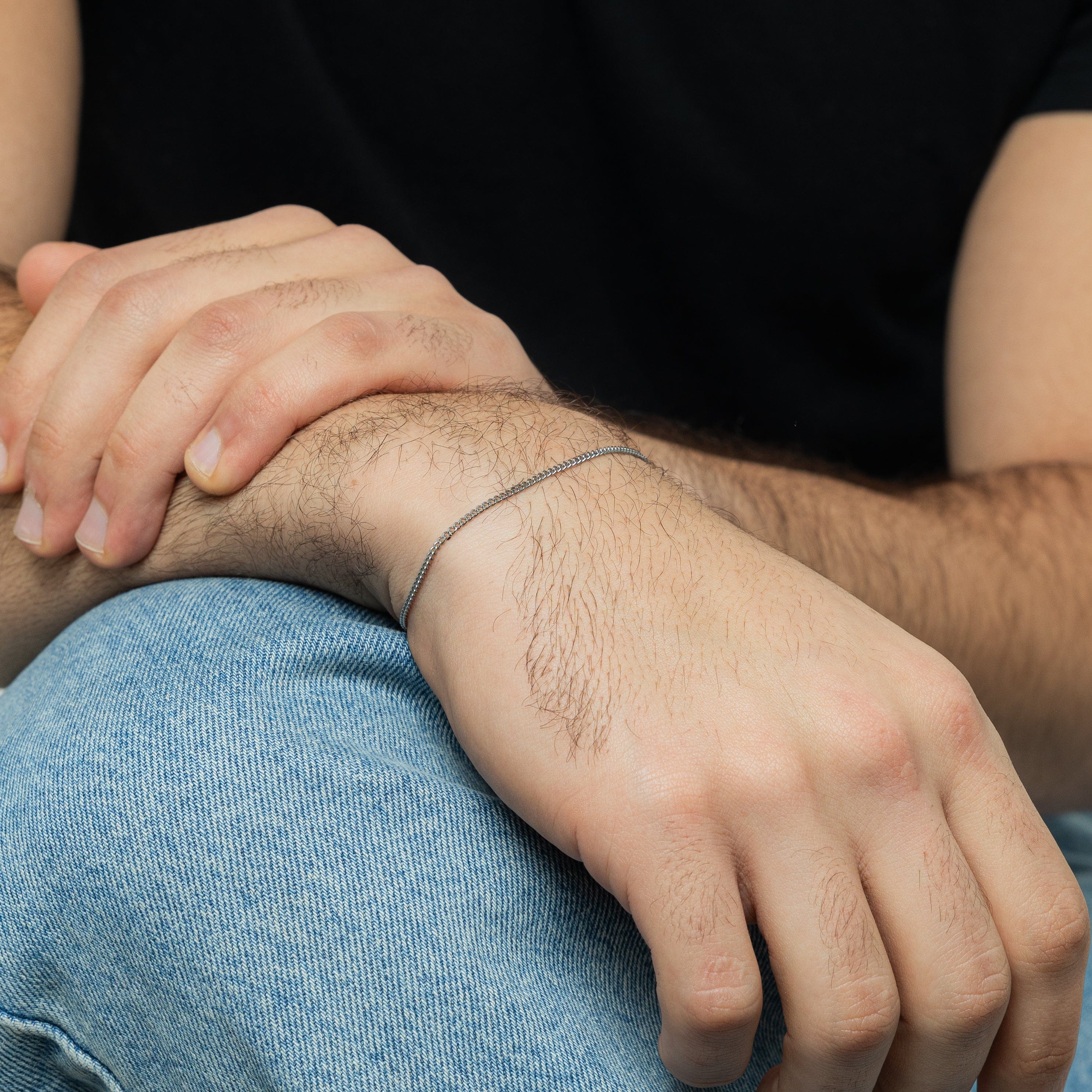 Men styling the Timeless Micro Chain Bracelet with a casual outfit, highlighting its versatility.