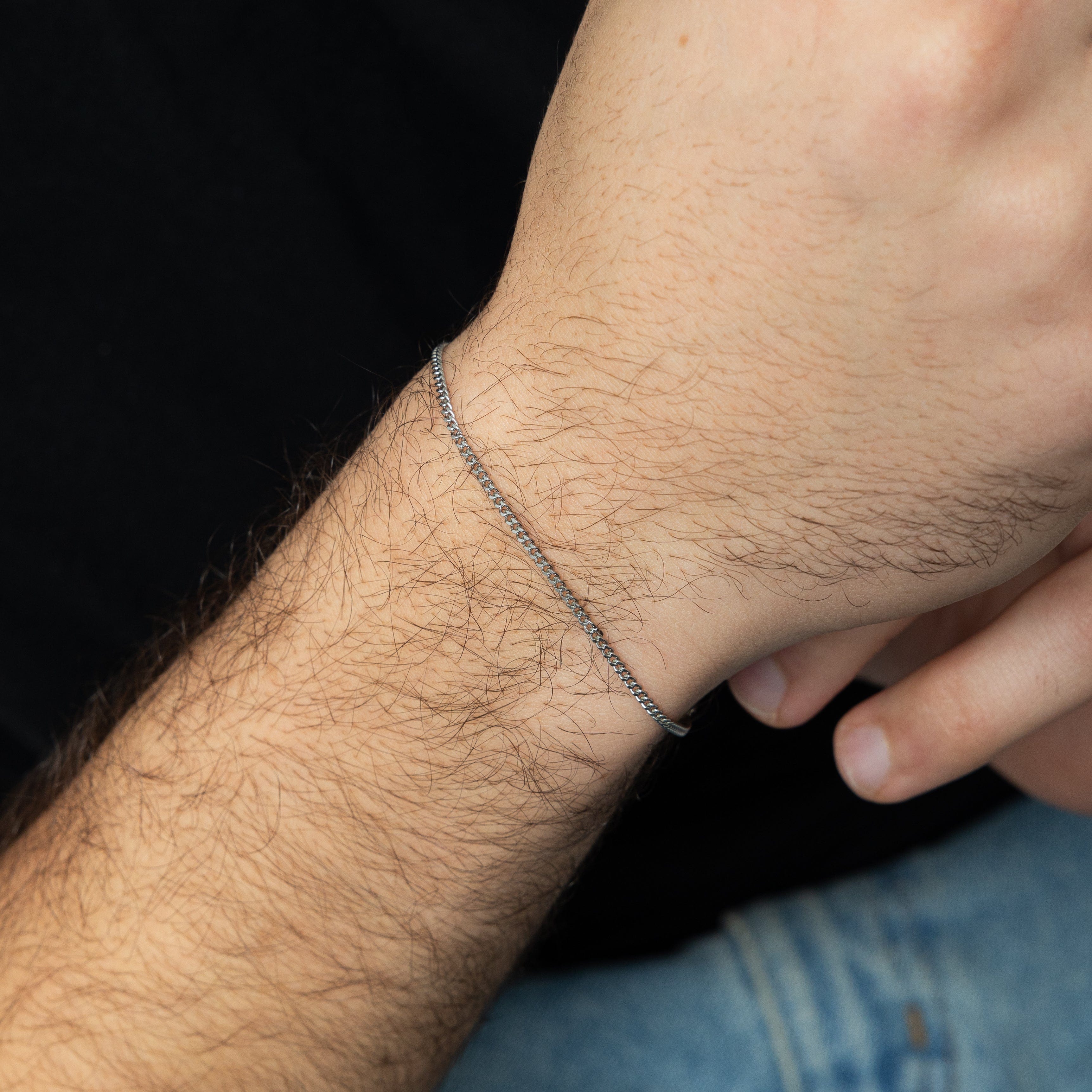 Men styling the Timeless Micro Chain Bracelet with a casual outfit, highlighting its versatility.