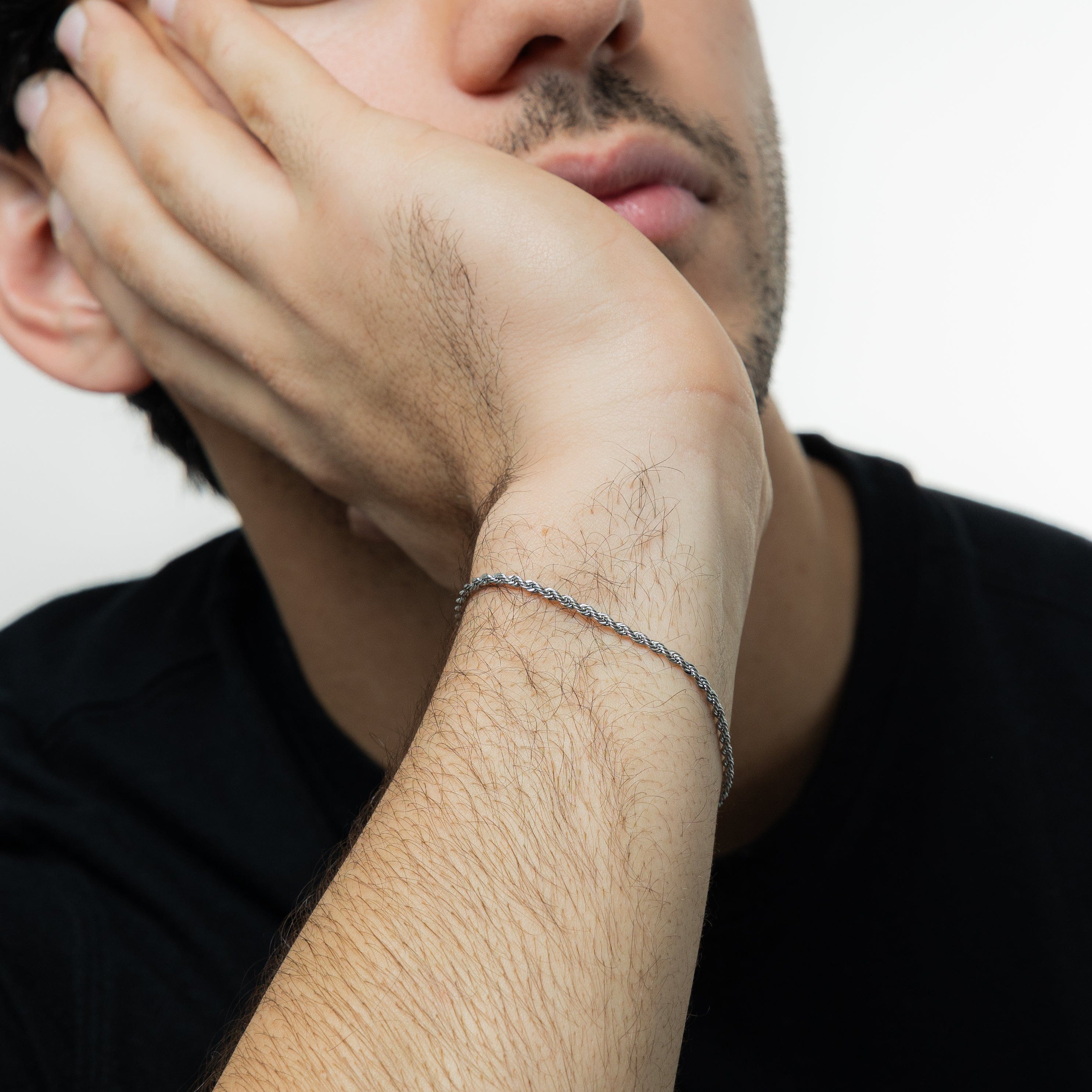 Titanium Micro Rope Bracelet worn by a man outdoors, showcasing its waterproof features.