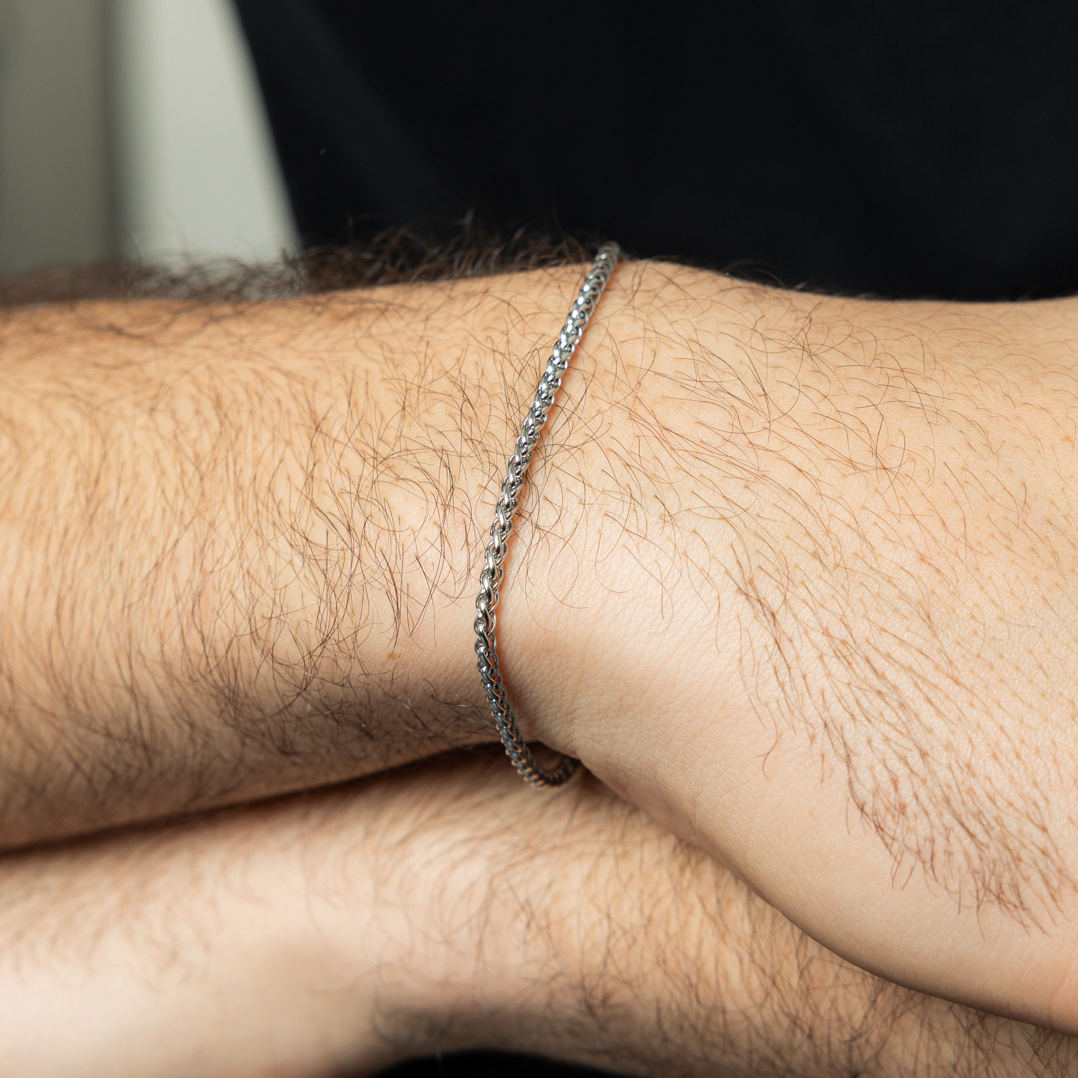 Mens wheat chain bracelet styled with casual attire, showcasing its versatility.