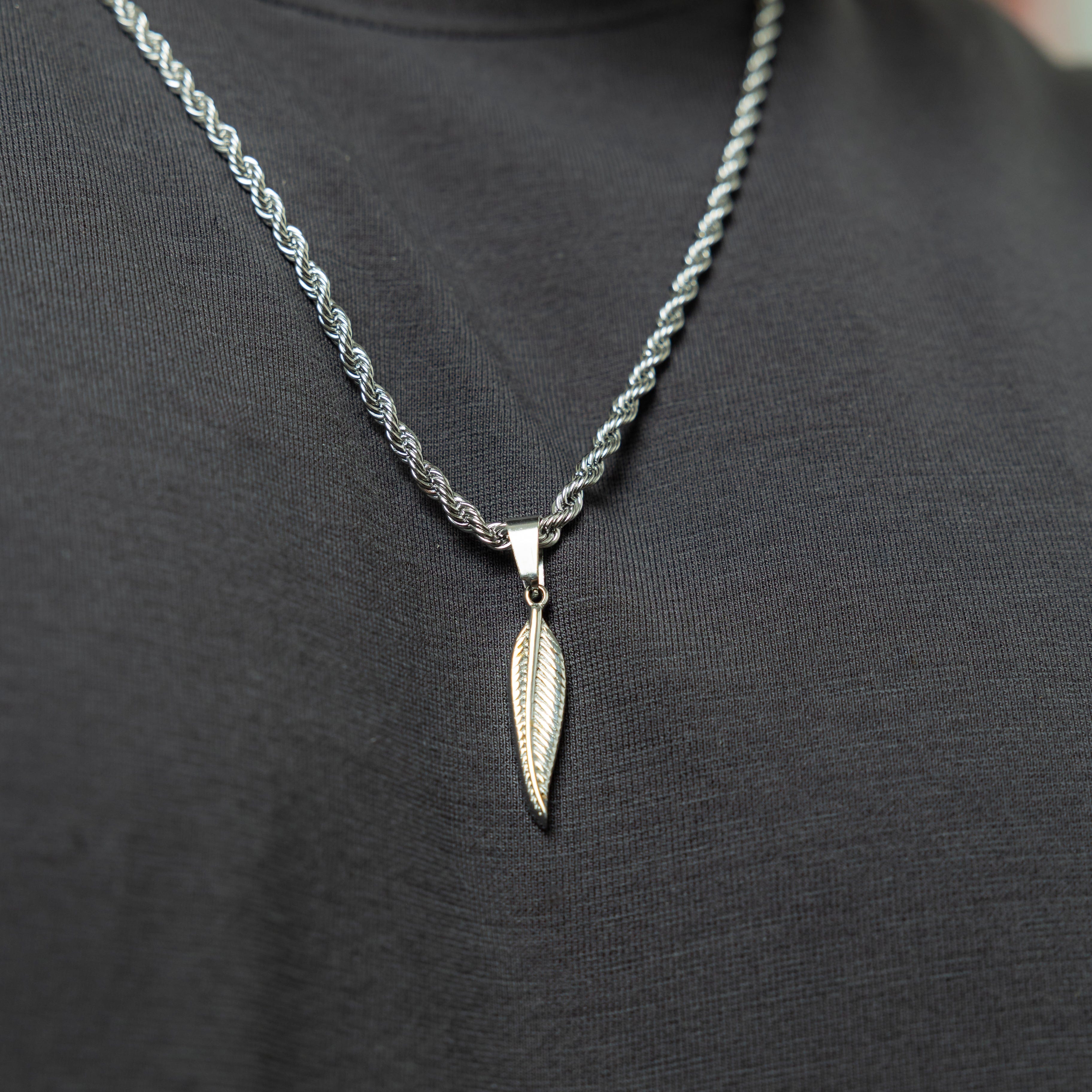 Model wearing the feather necklace, demonstrating its stylish and minimalist appeal.