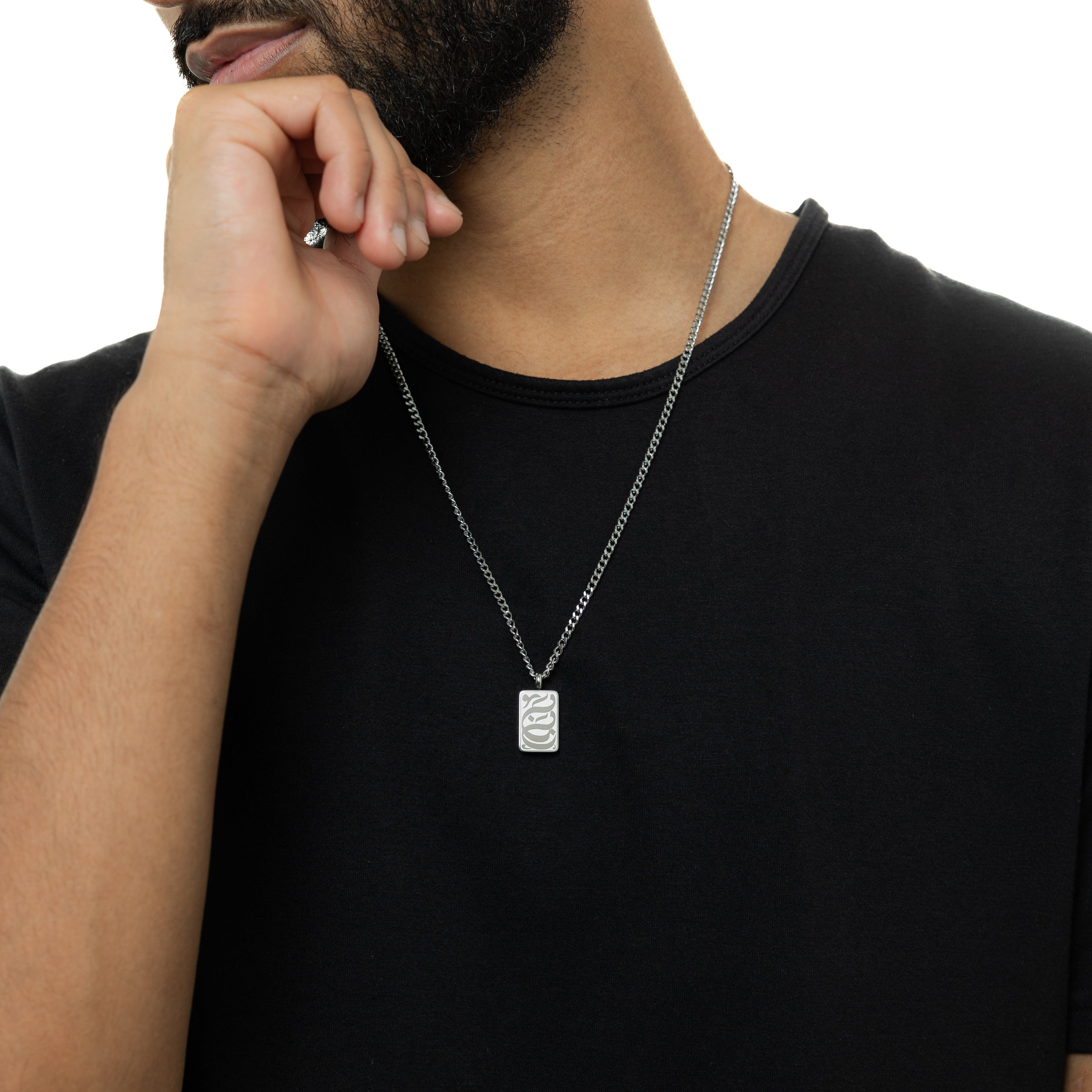 Close-up view of Baba engraved tag necklace showcasing Arabic engraving.
