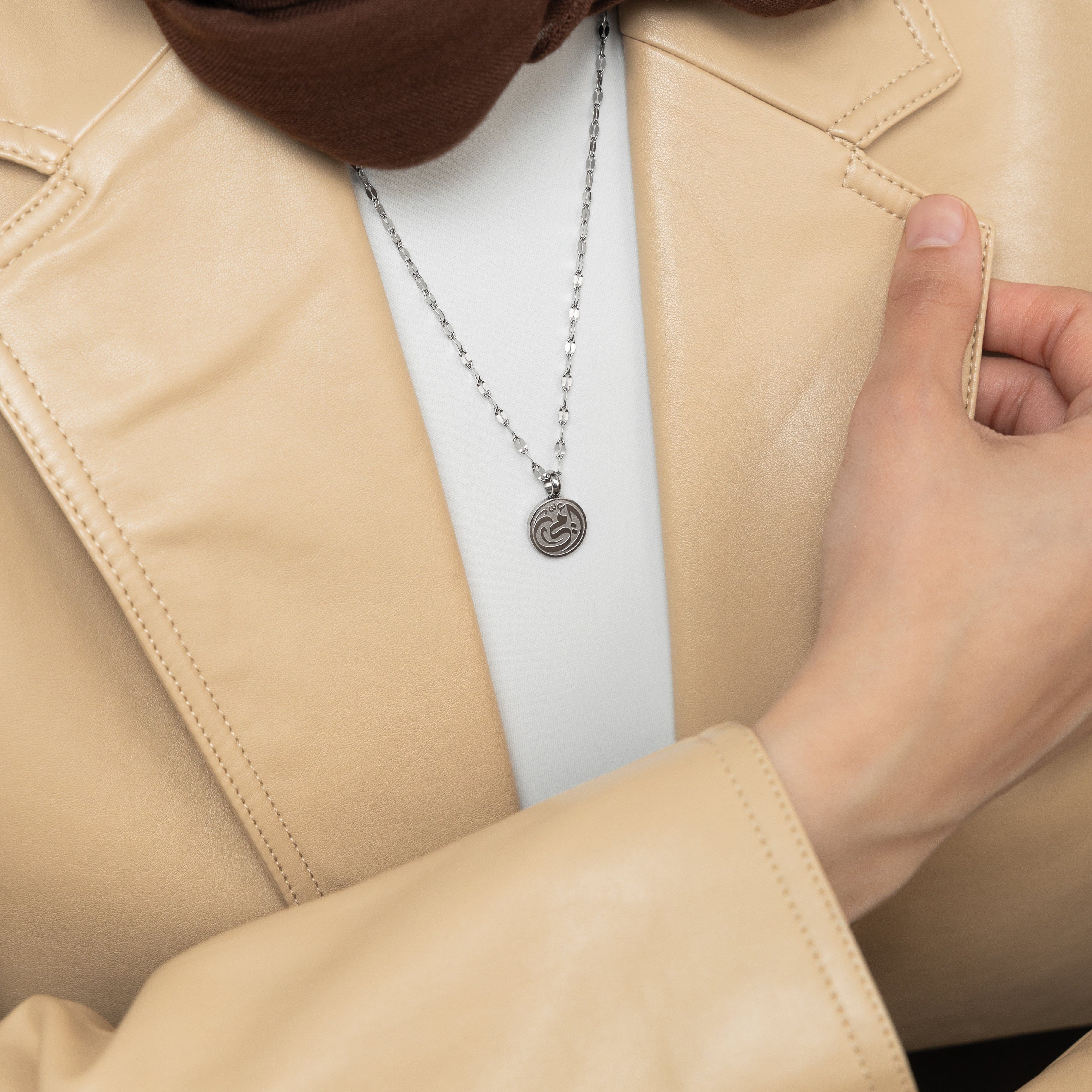 Lifestyle image of a woman wearing the mother necklace, reflecting its beauty and elegance in everyday life.