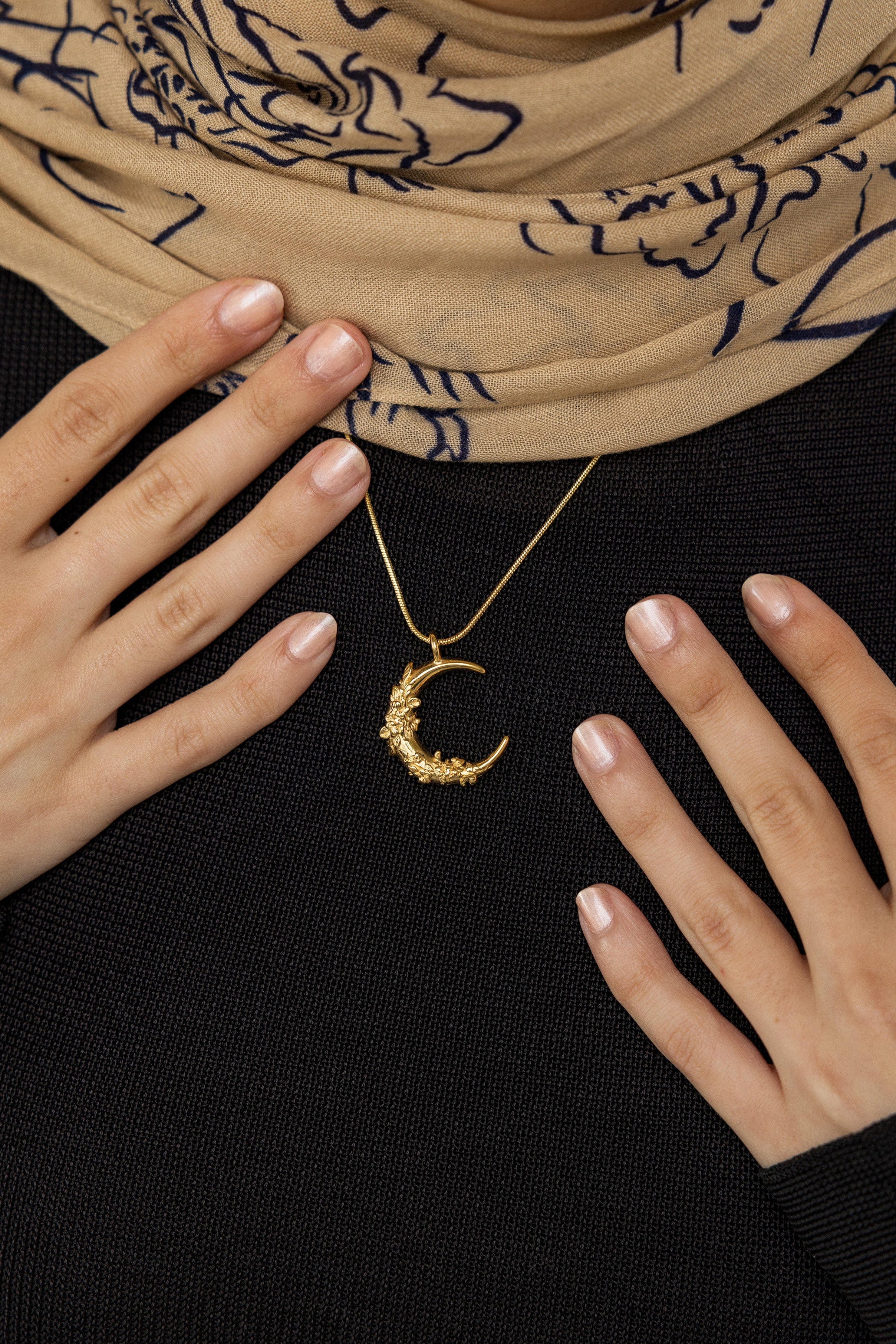 Model wearing the jasmine crescent necklace, showcasing its elegance and charm.