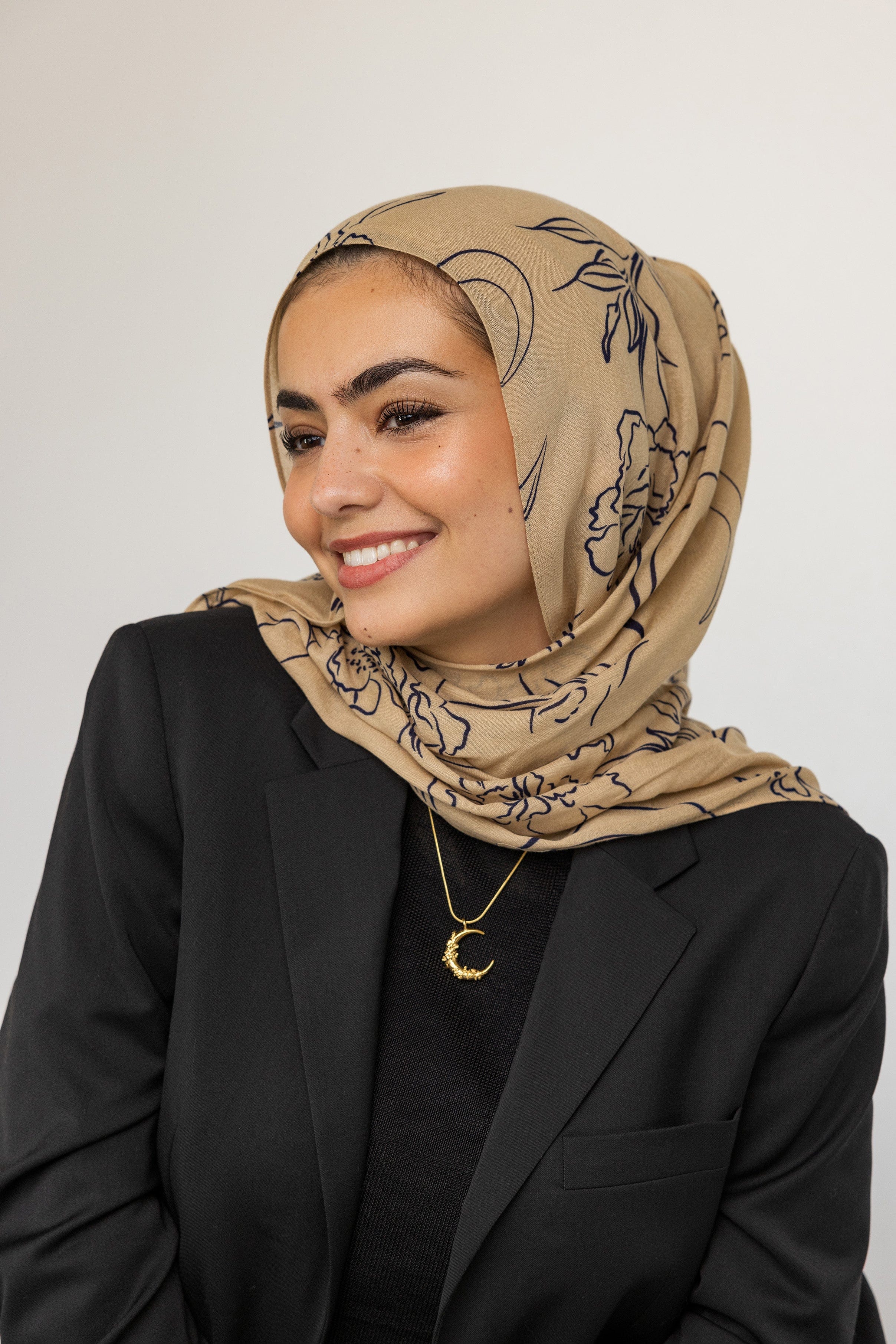Model wearing the jasmine crescent necklace, showcasing its elegance and charm.