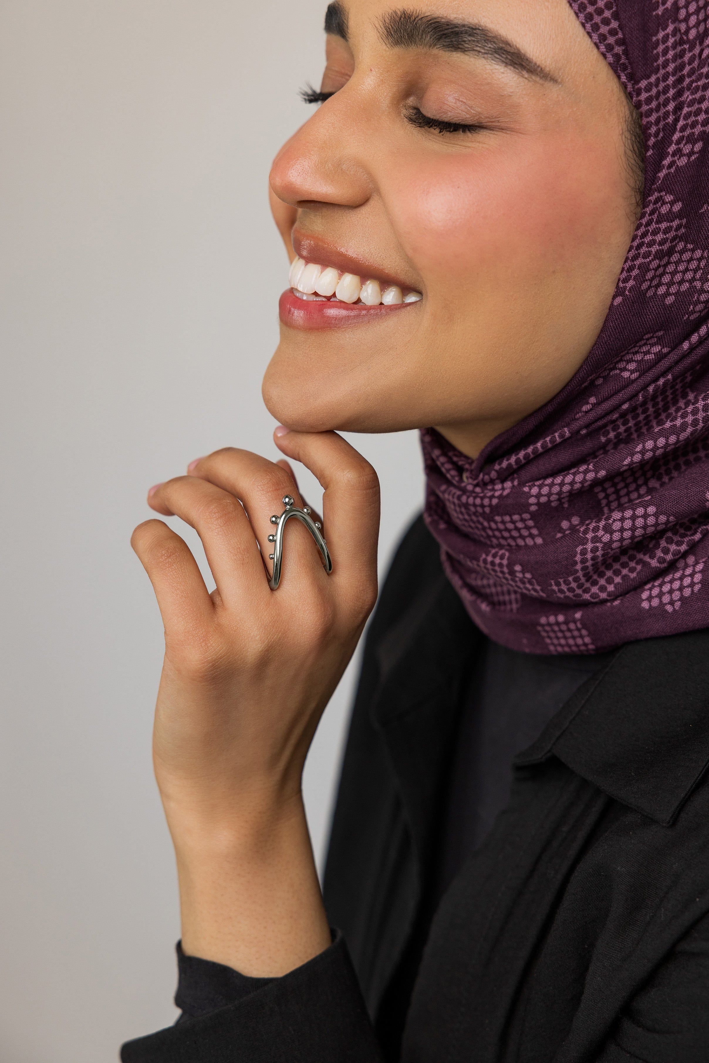 Close-up of the Celestial Harmony Ring on a models hand, emphasizing its beauty and shine.