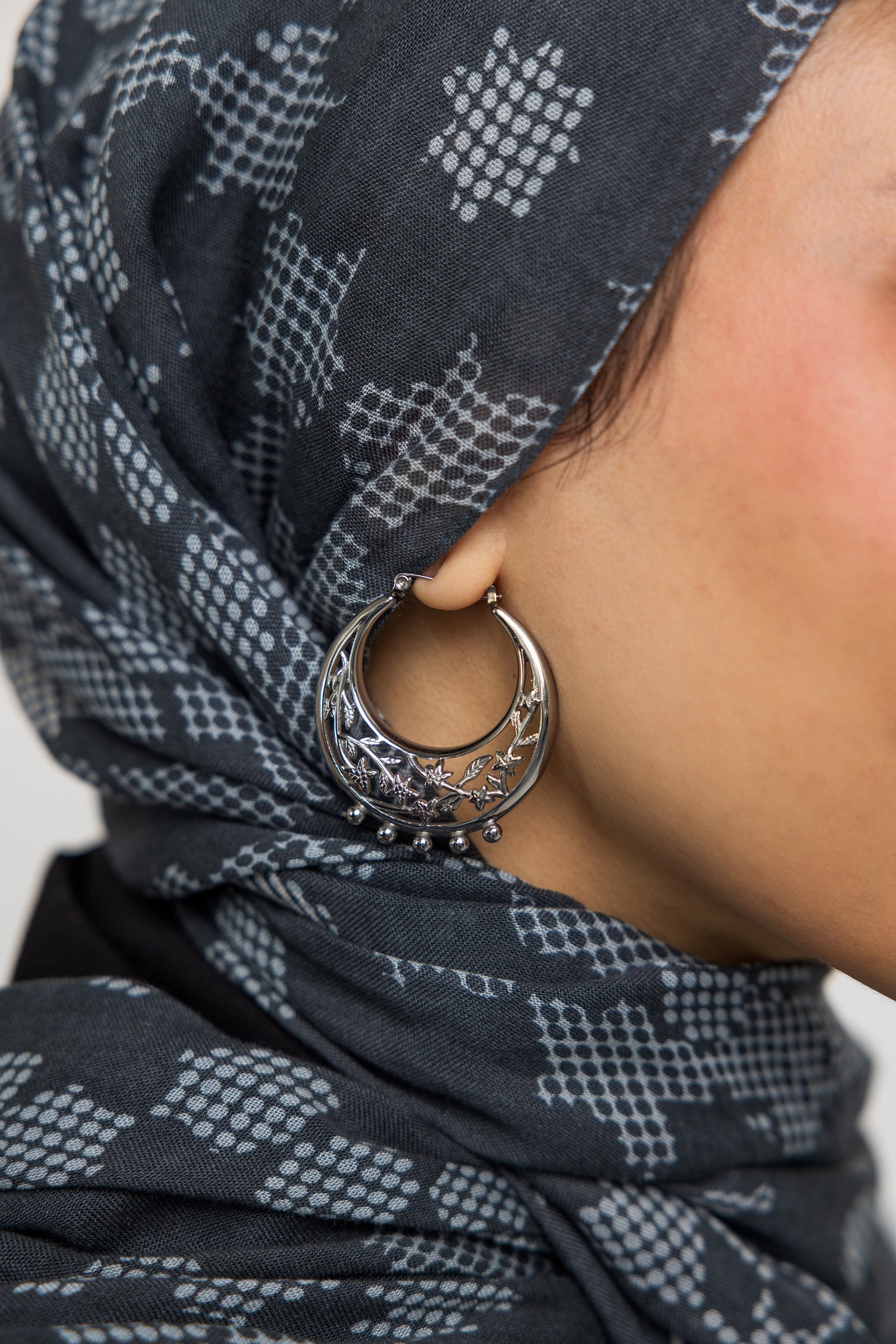Model wearing trendy gold earrings for everyday wear in outdoor setting.