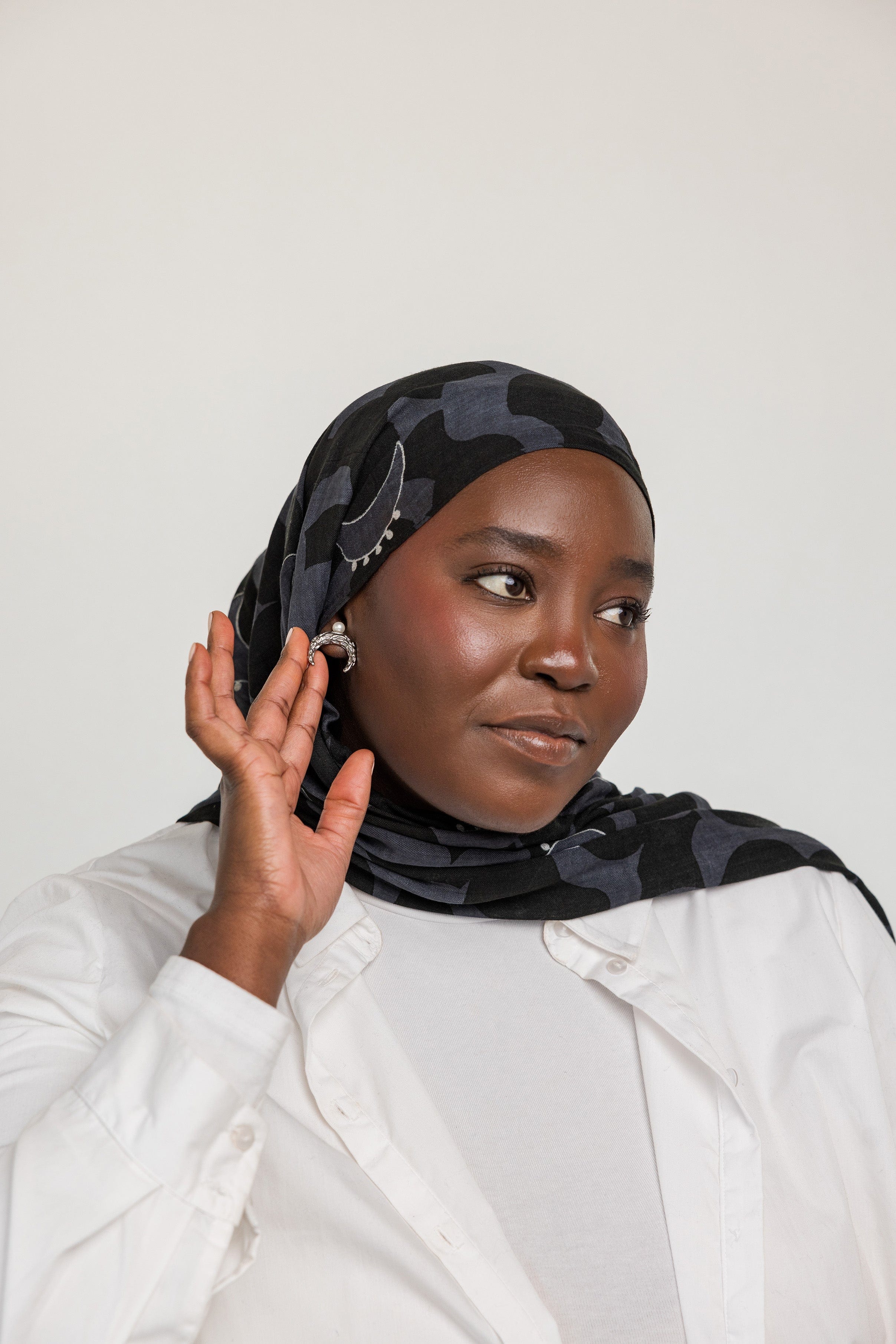 Model wearing Cascading Pearl Crescent Earrings, demonstrating their versatility from casual to formal attire.