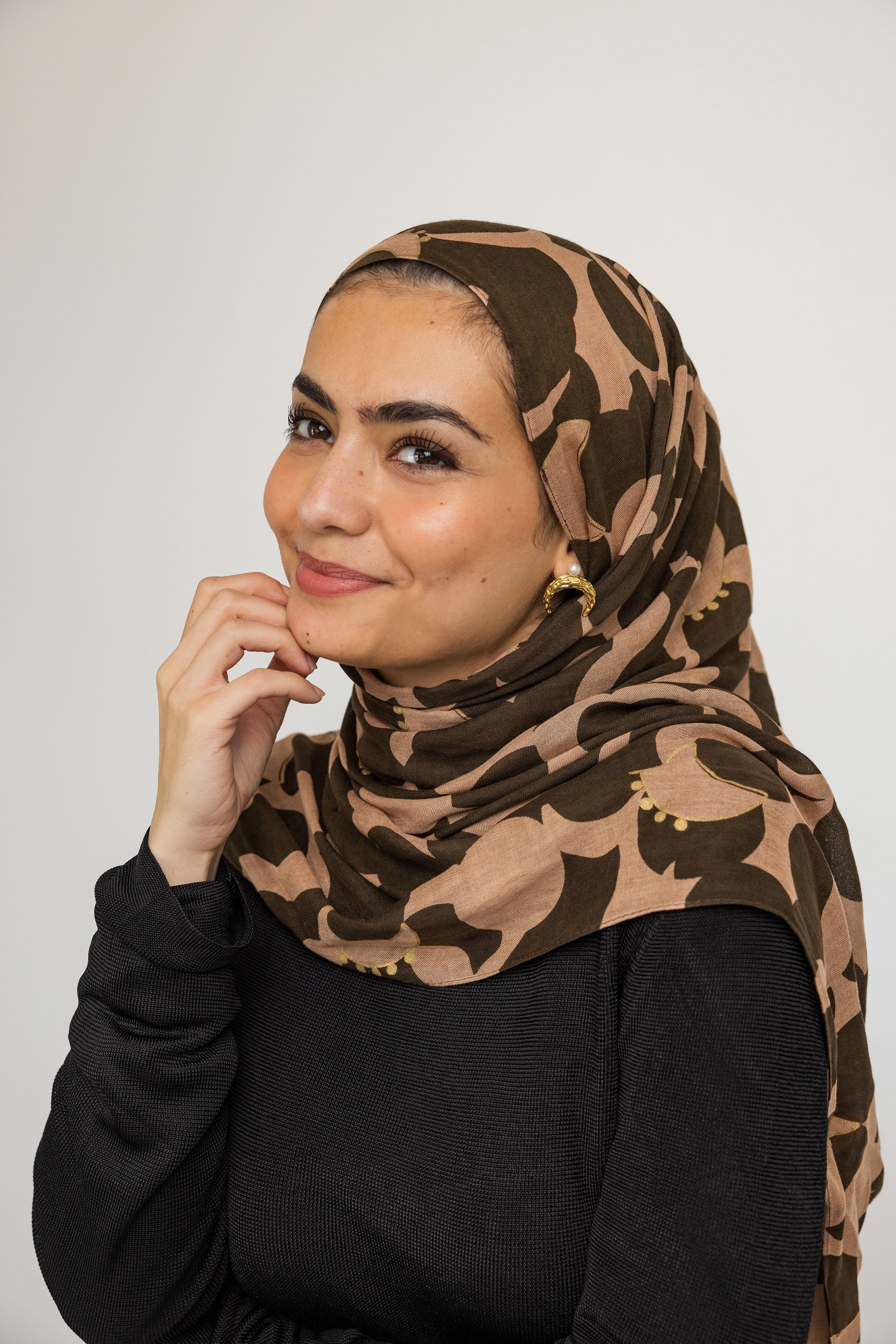 Model wearing Cascading Pearl Crescent Earrings, demonstrating their versatility from casual to formal attire.