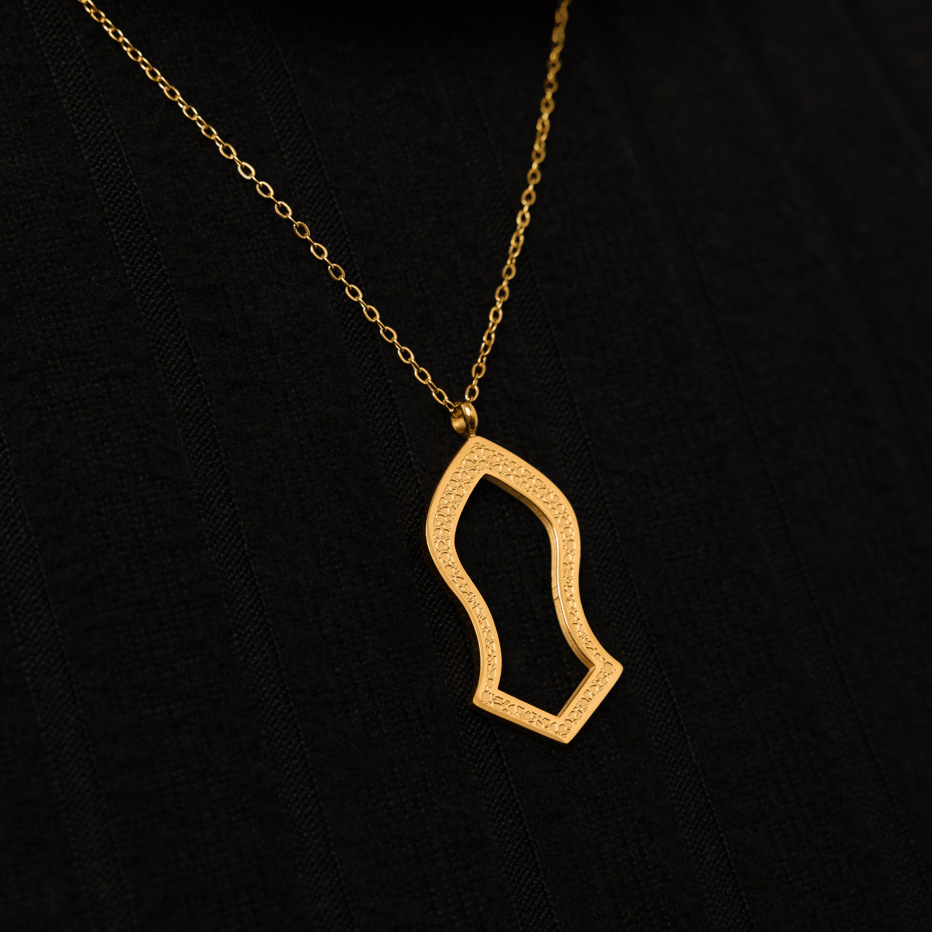Close-up of the gold pendant showcasing geometric patterns, ideal for sensitive skin.