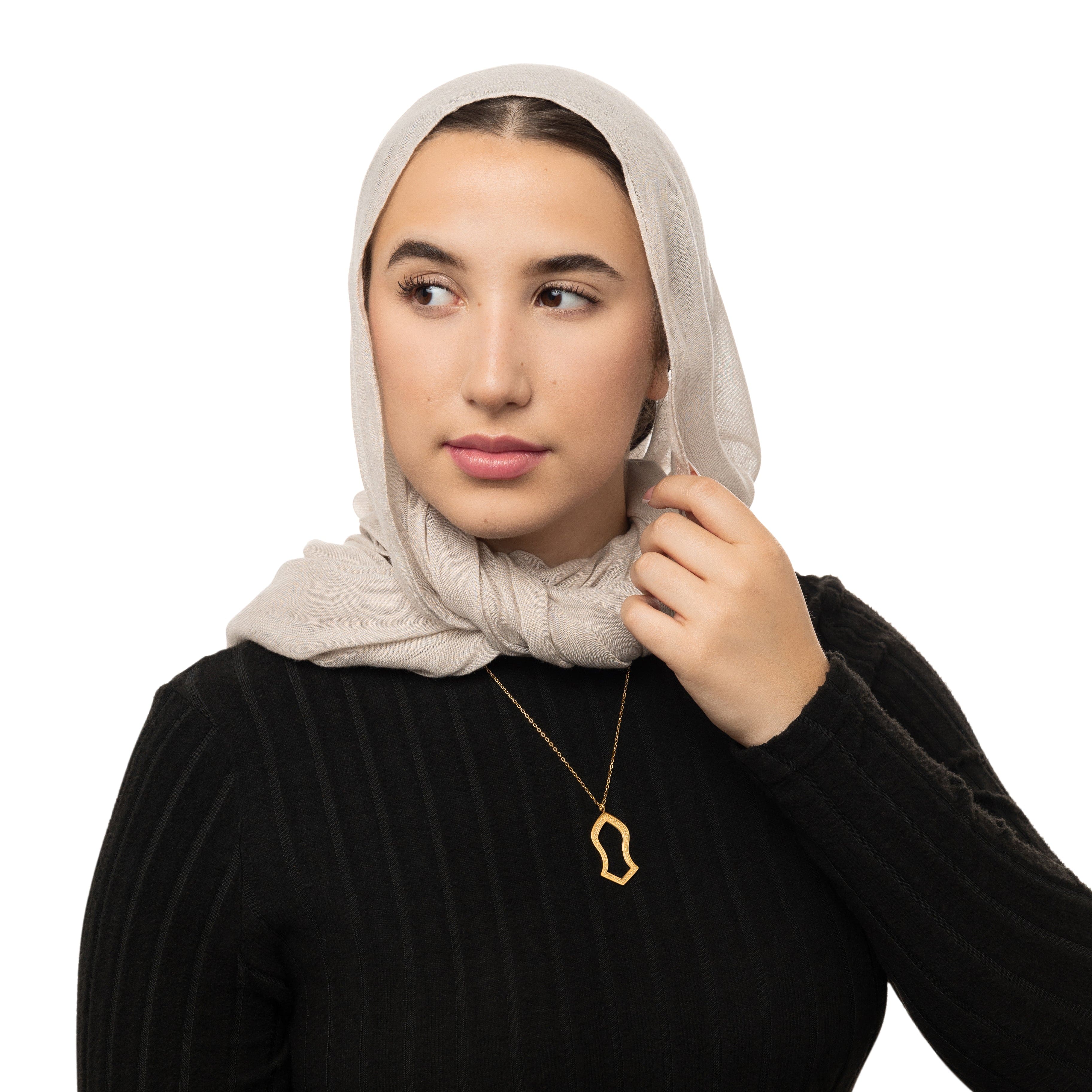 Noble Sandal Gold Pendant Necklace displayed on a velvet pouch, highlighting its intricate design.
