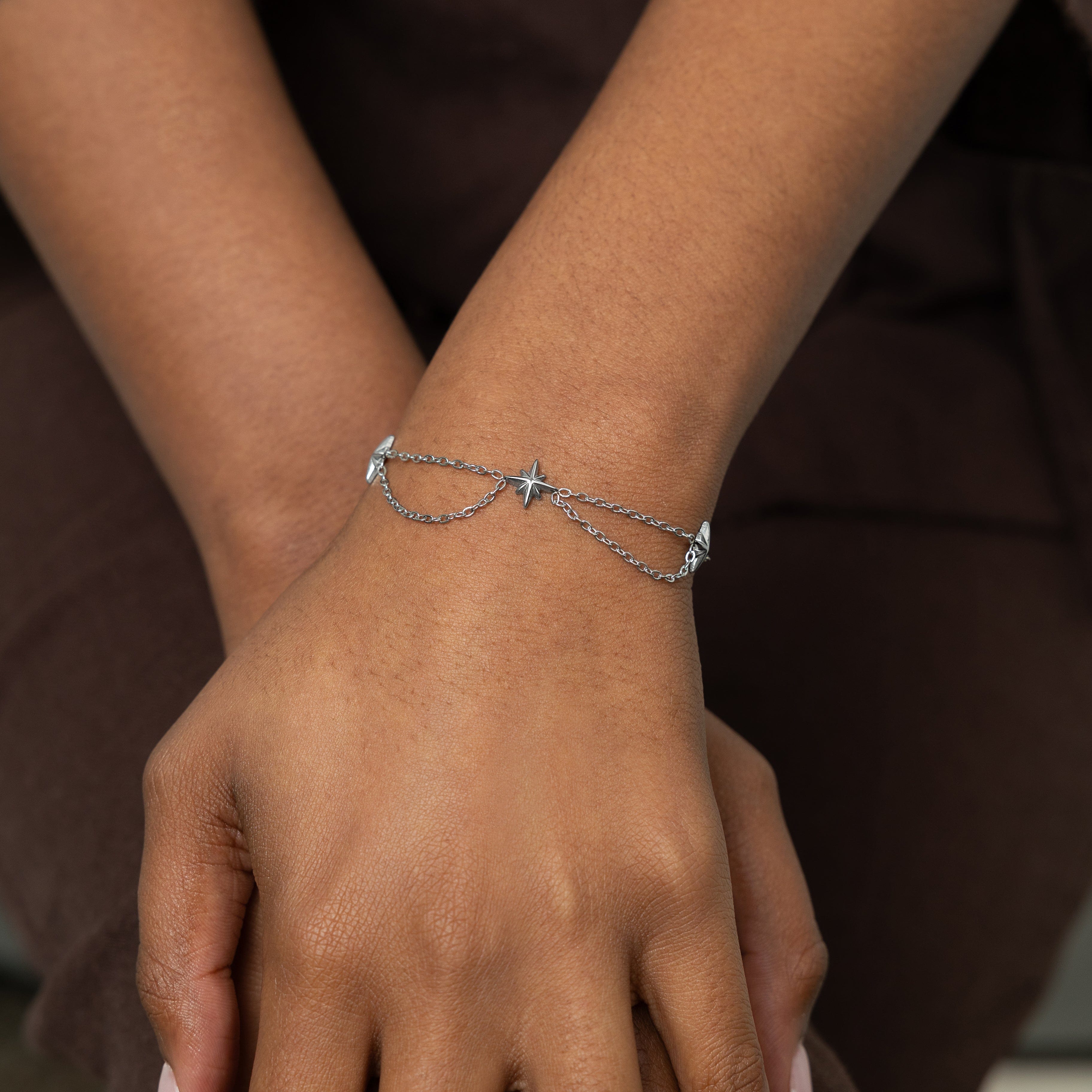 Woman wearing the Guiding Star Bracelet, showcasing its stylish design and comfortable fit.