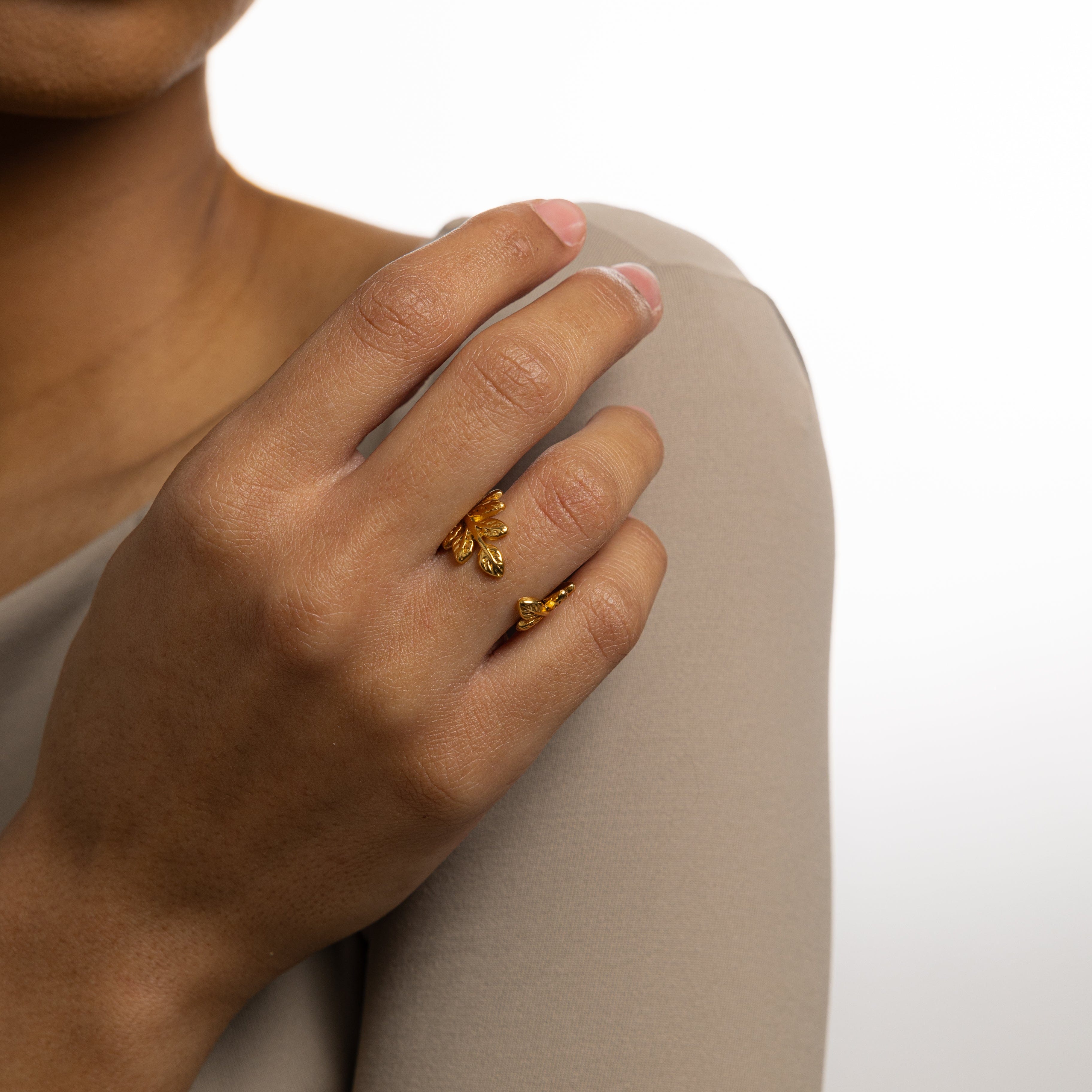 Trendy olive branch ring showcased on a velvet background, highlighting its elegant design.