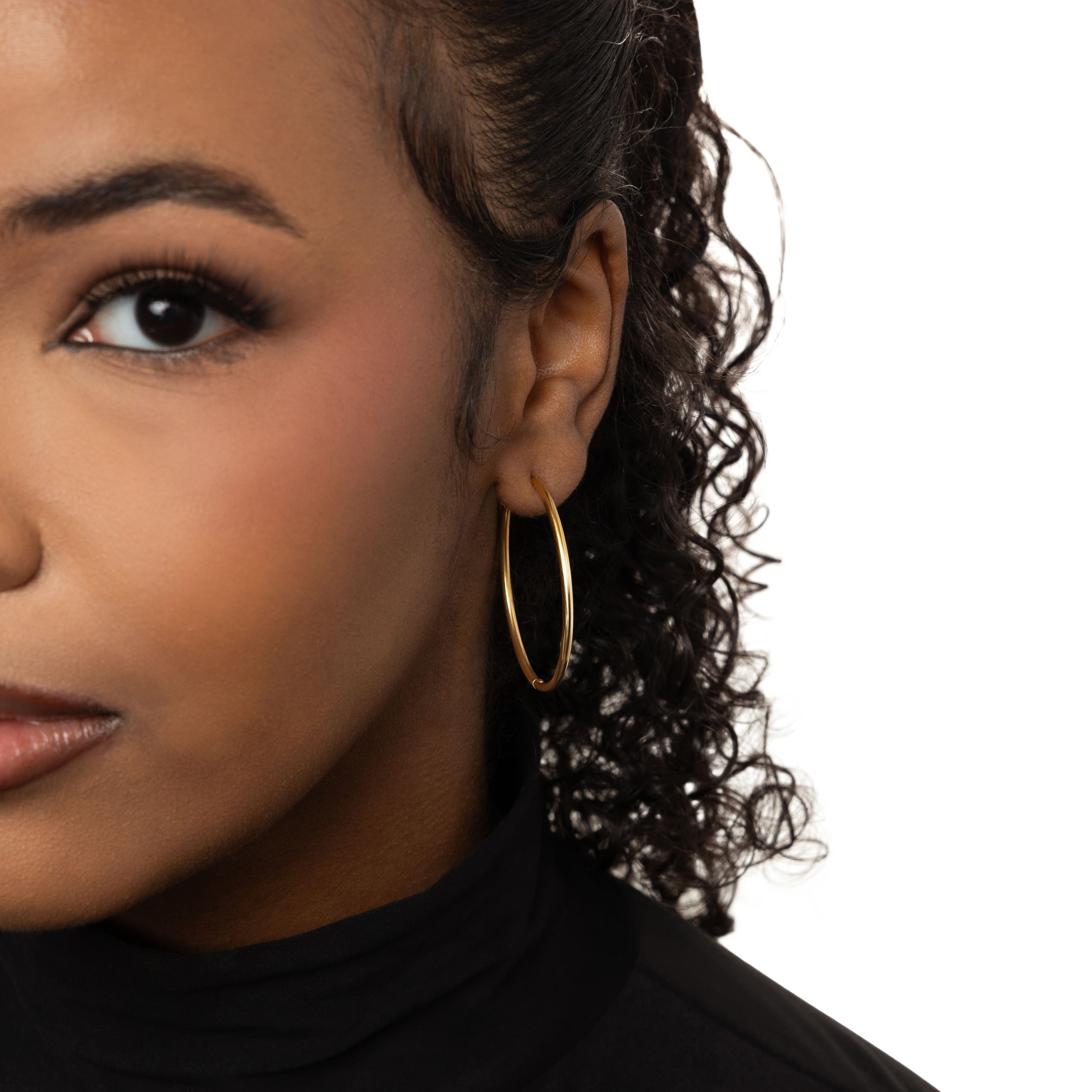 Elegant display of waterproof 40mm hoop earrings in a velvet pouch.