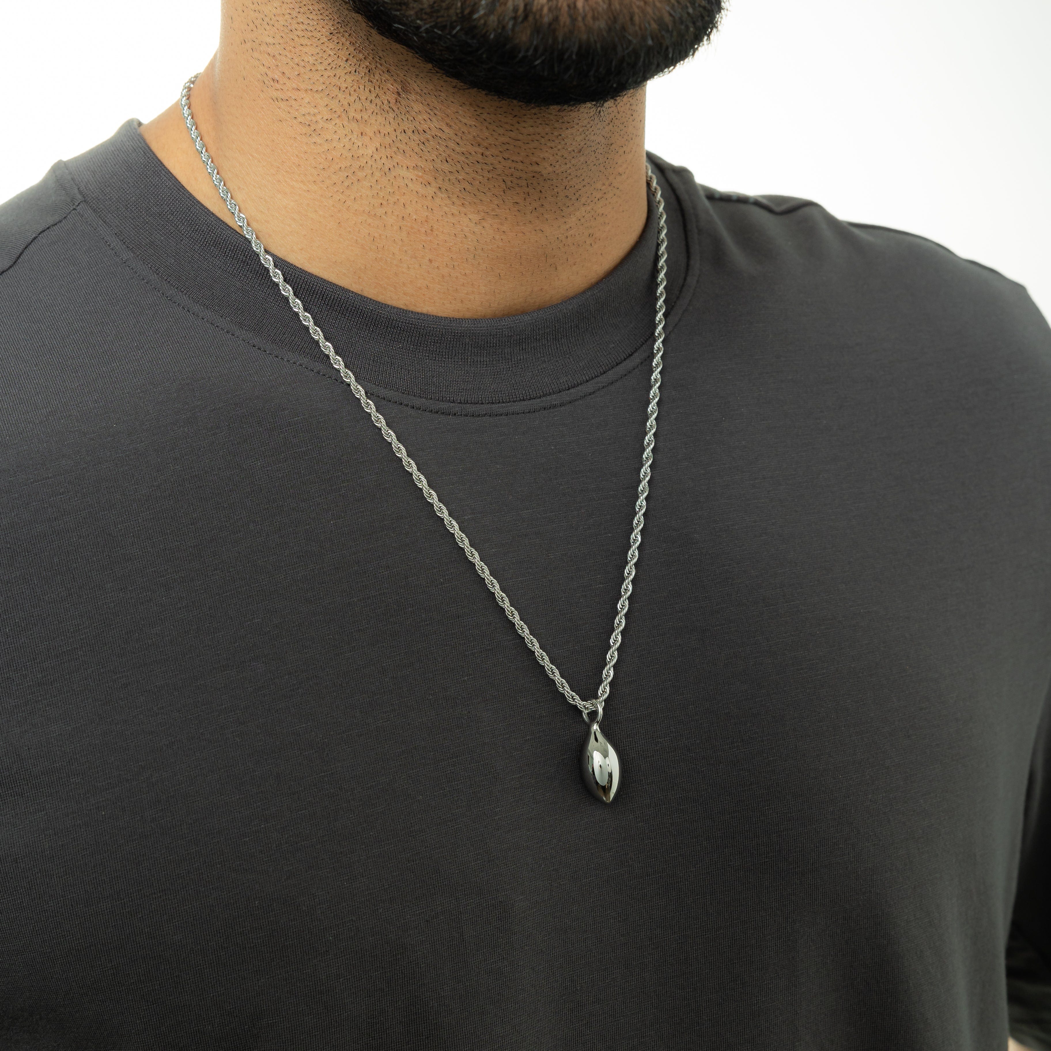 The premium stainless steel chain lying flat with pendant, emphasizing quality and everyday wear.