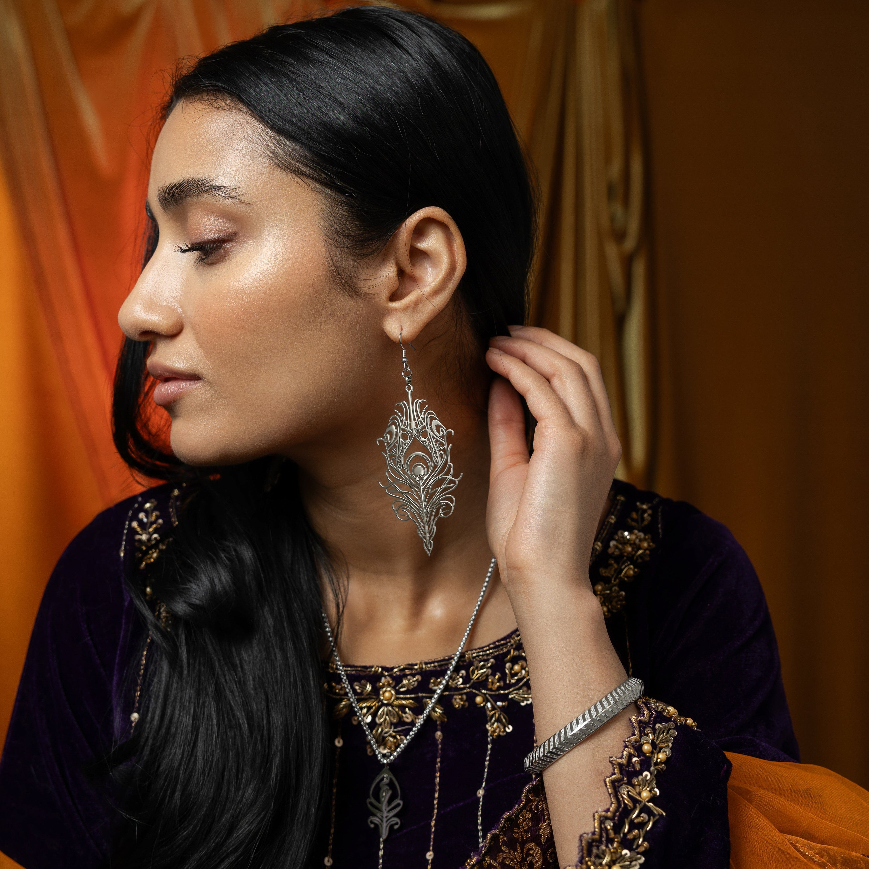 Eternal Bond earrings worn by a model, highlighting their elegant appeal and spiritual significance.