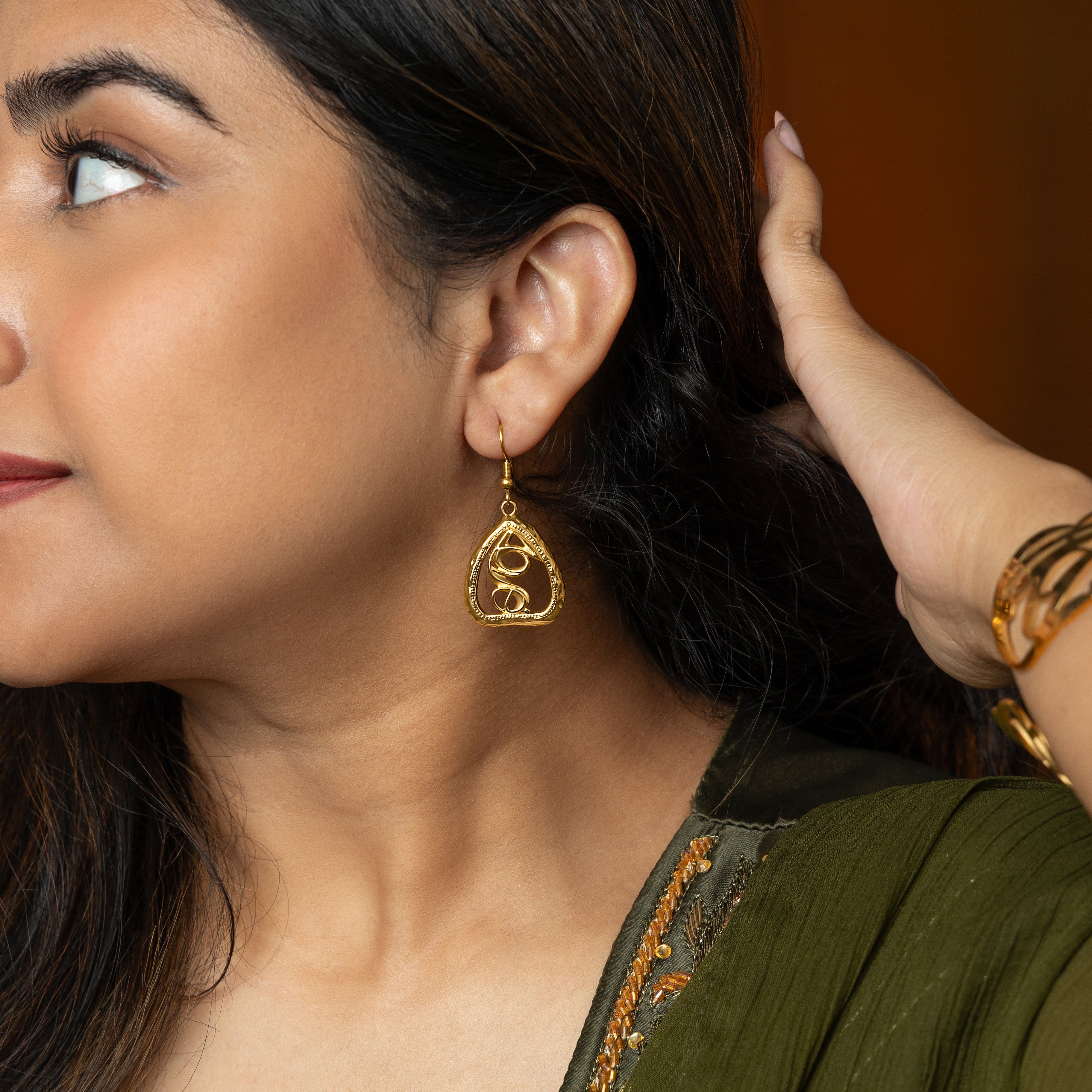 Lifestyle image of a model wearing Hypoallergenic Gold Earrings, perfect for special occasions.