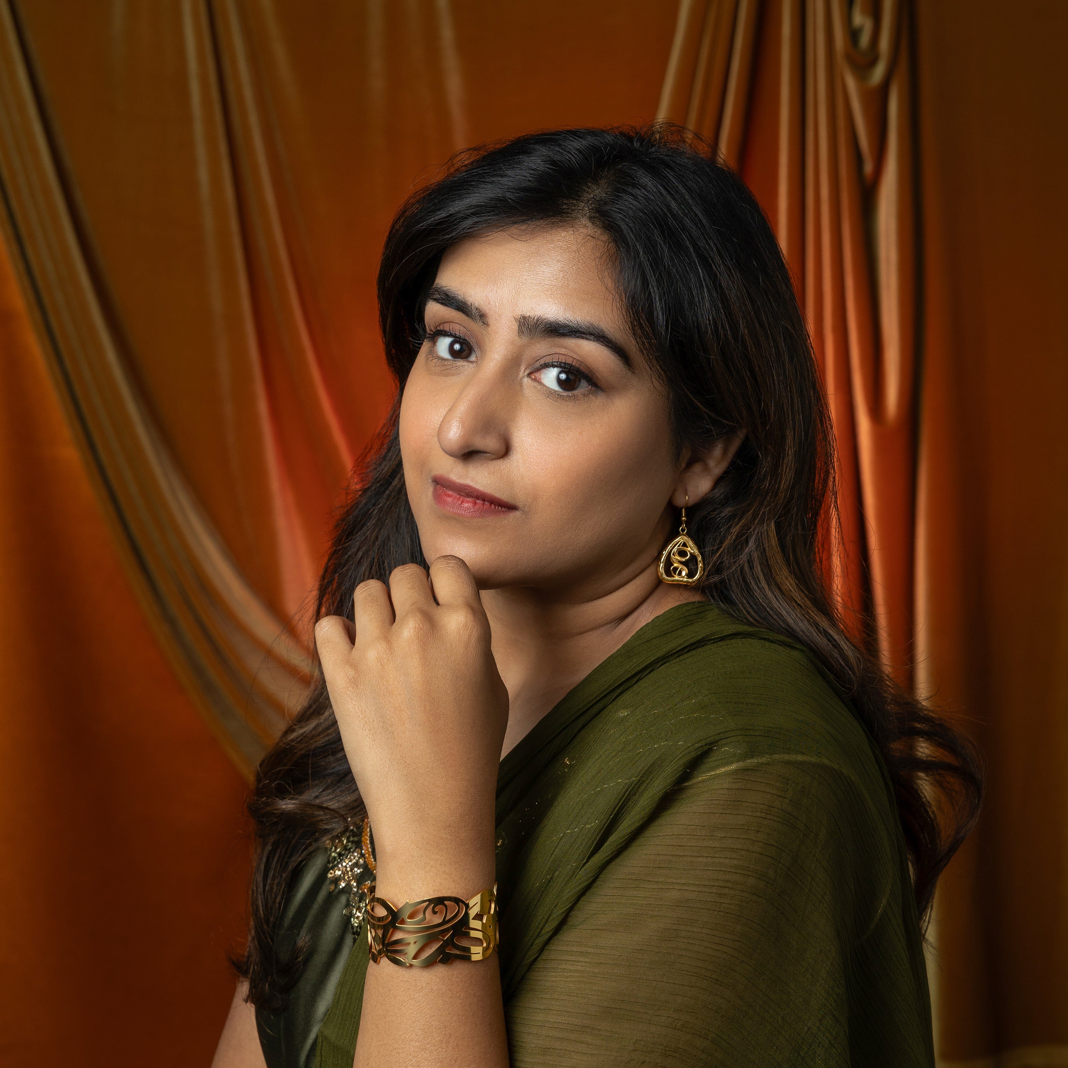 Lifestyle image of a model wearing Hypoallergenic Gold Earrings, perfect for special occasions.