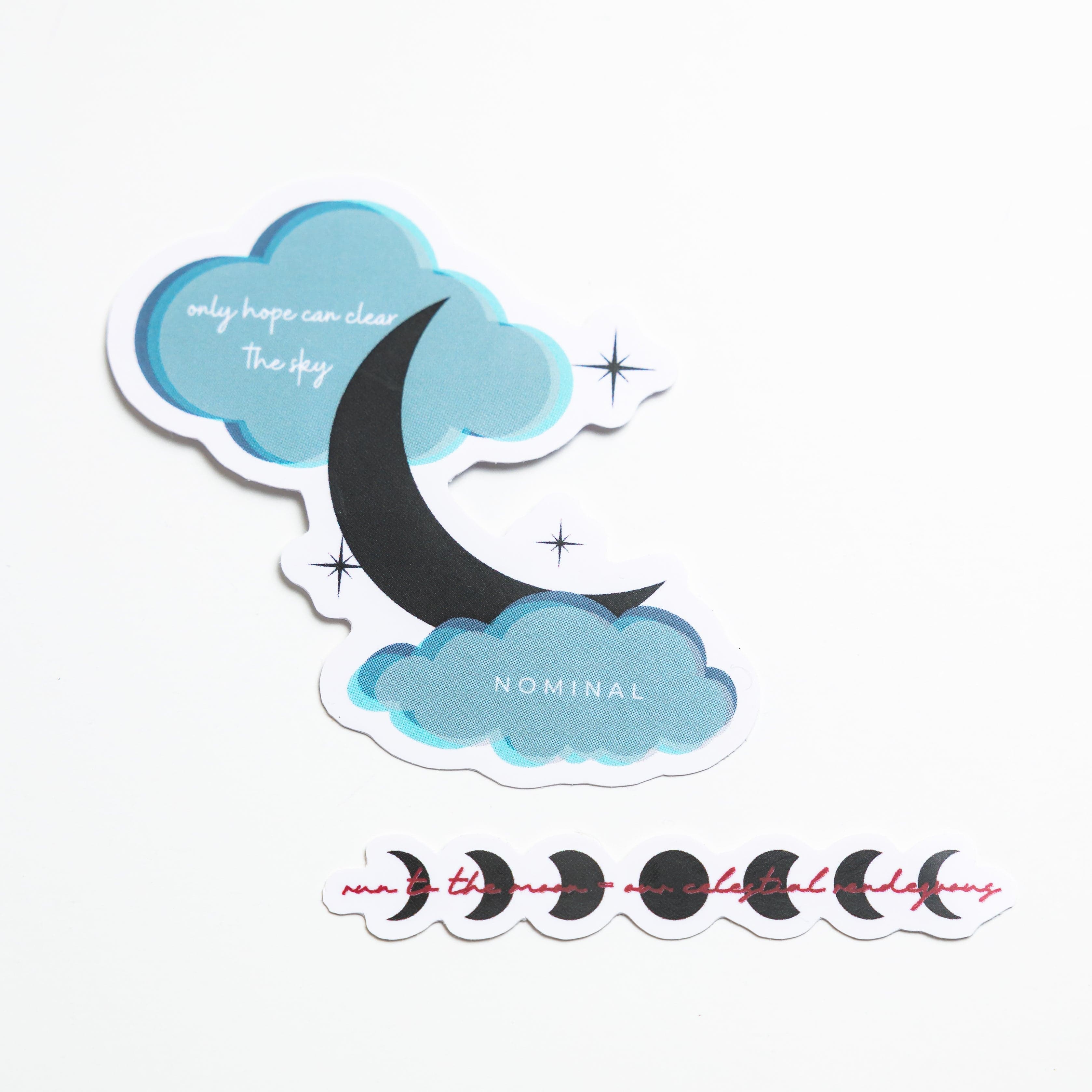 Crescent moon sticker peeking through clouds, symbolizing hope.