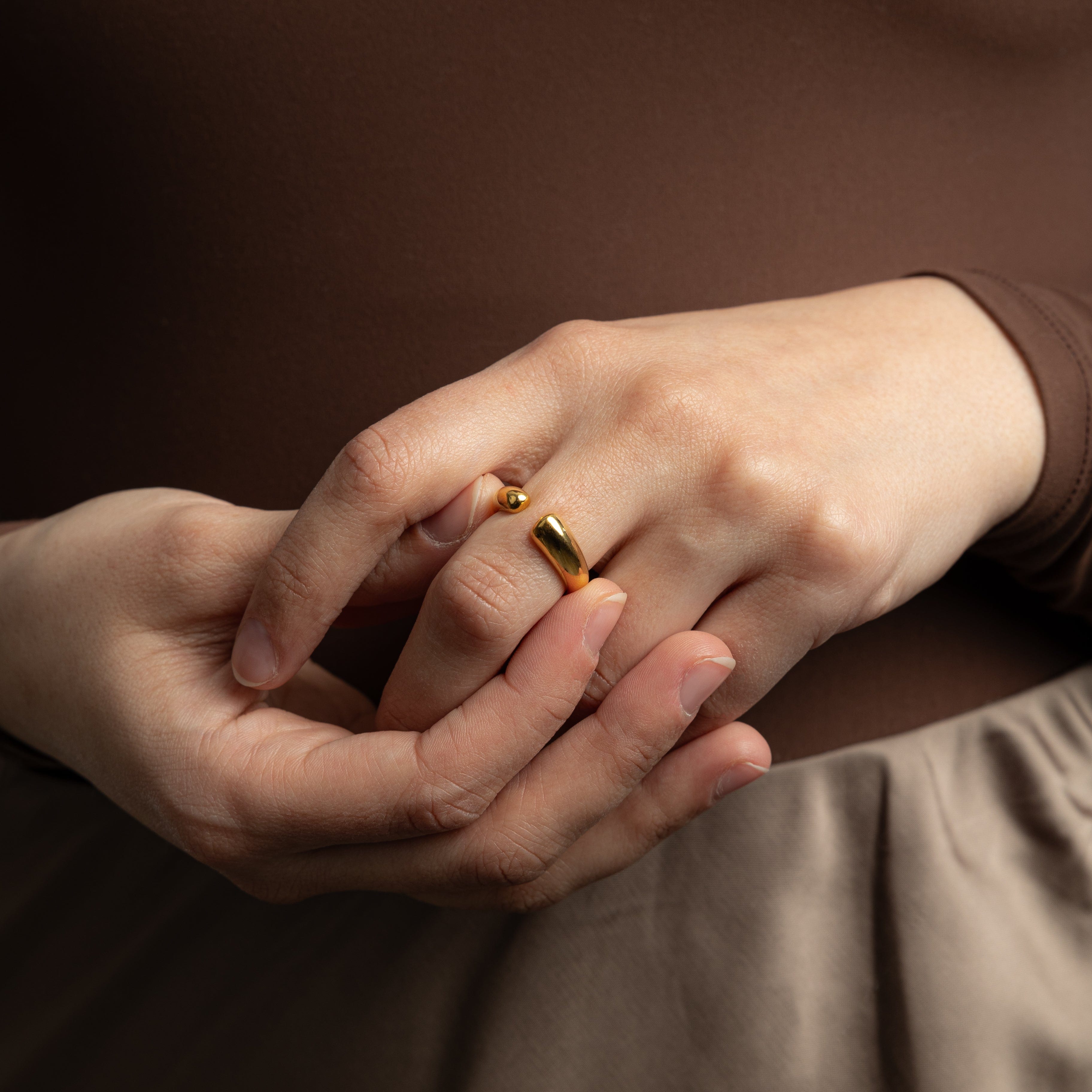 Lifestyle image of Aurora Curve worn alone as a statement piece.
