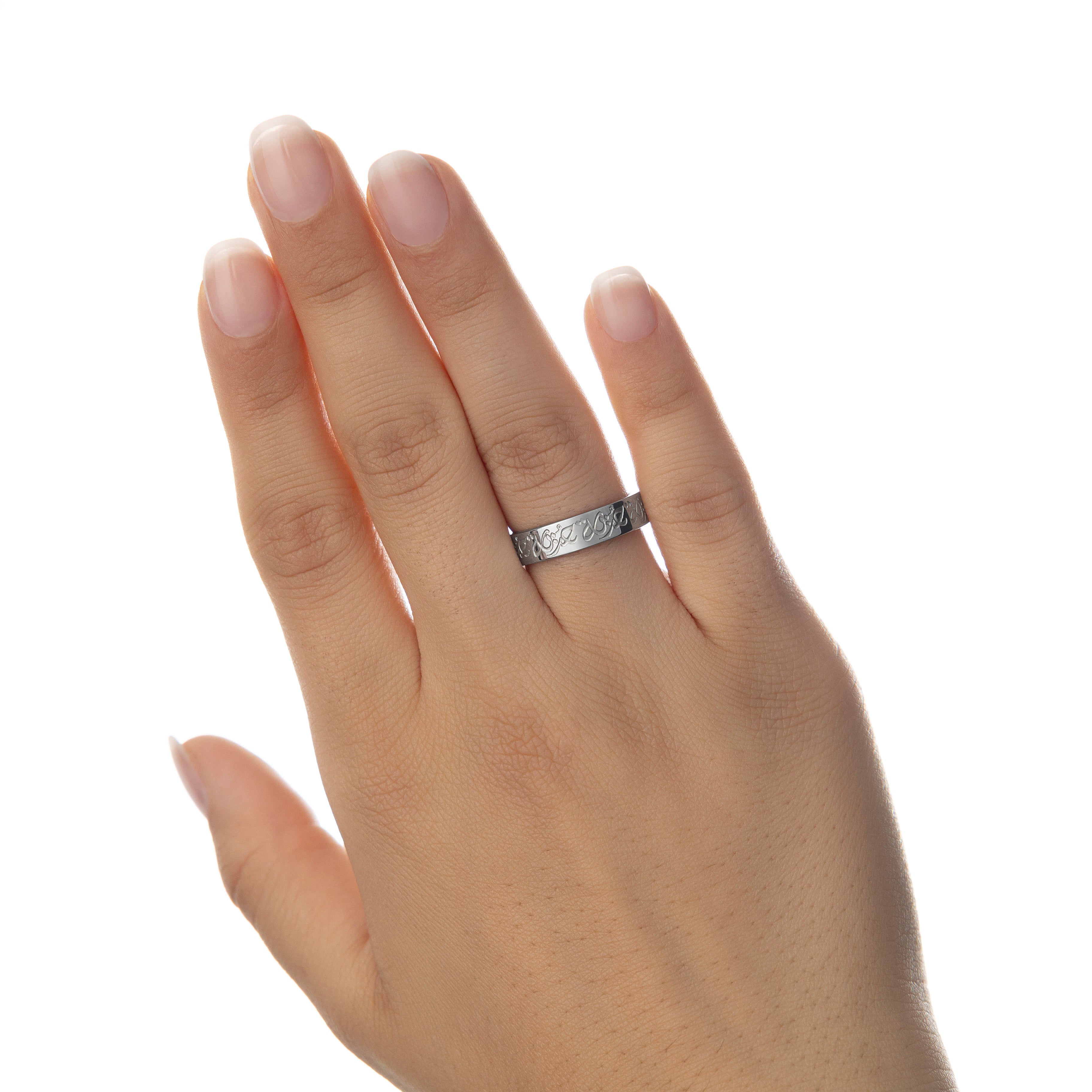 Close-up of the Rahma Mercy Ring showcasing its intricate Arabic engraving and gold plating.
