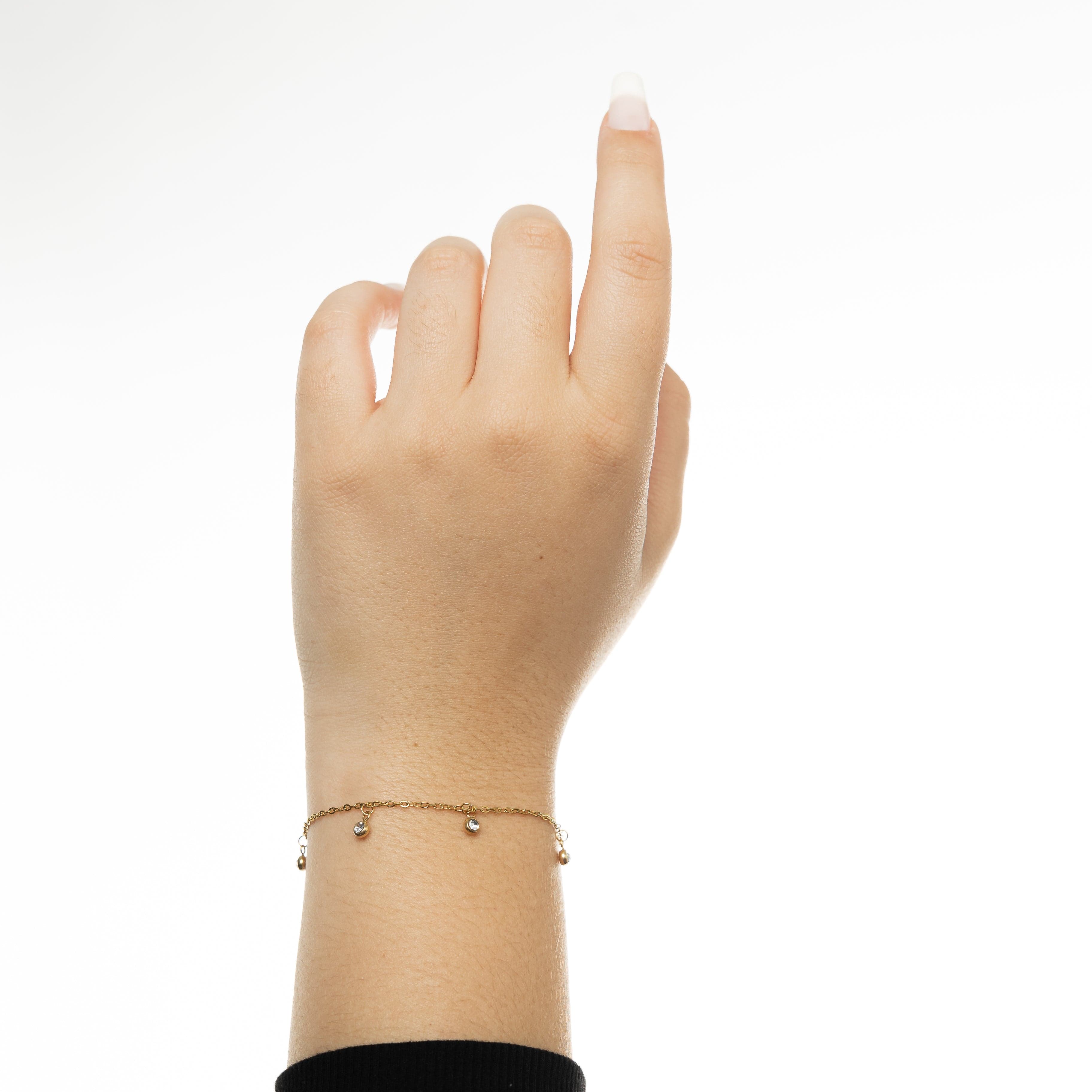 Water-resistant gold bracelet resting on velvet pouch, highlighting its premium finish