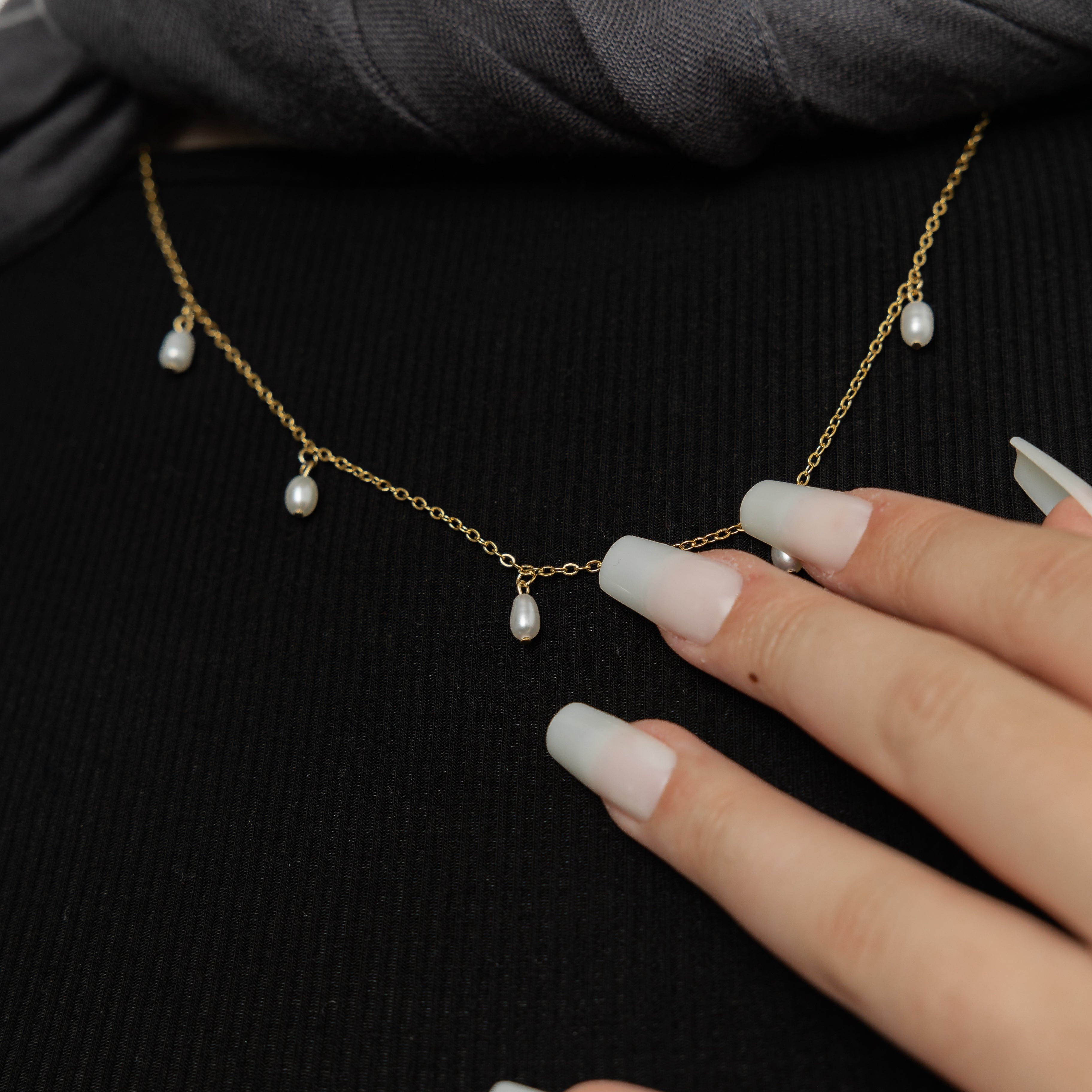 Close-up of the Luminous Raining Pearls Necklace highlighting the 18K gold plating and freshwater pearls.