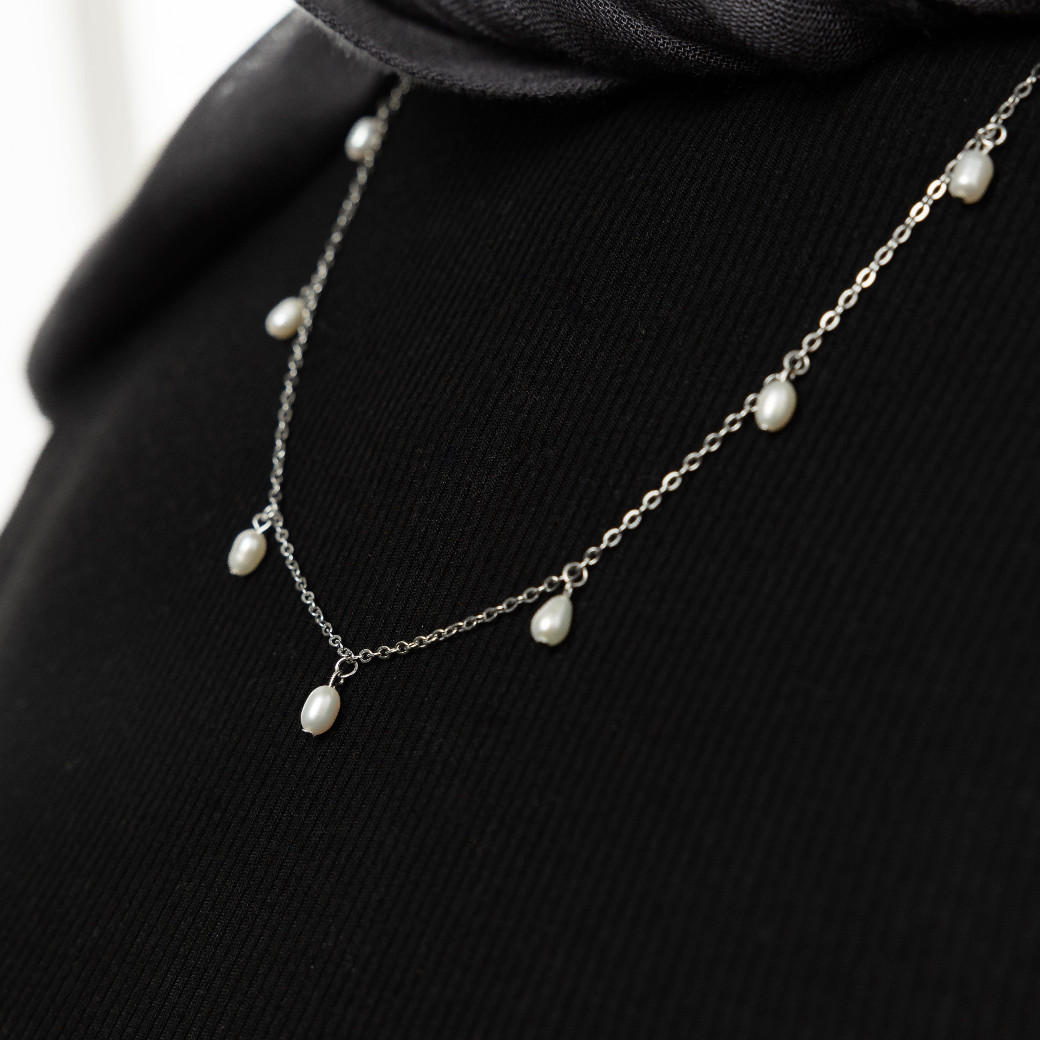 Model wearing the Luminous Raining Pearls Necklace at a wedding, demonstrating its elegance and versatility.