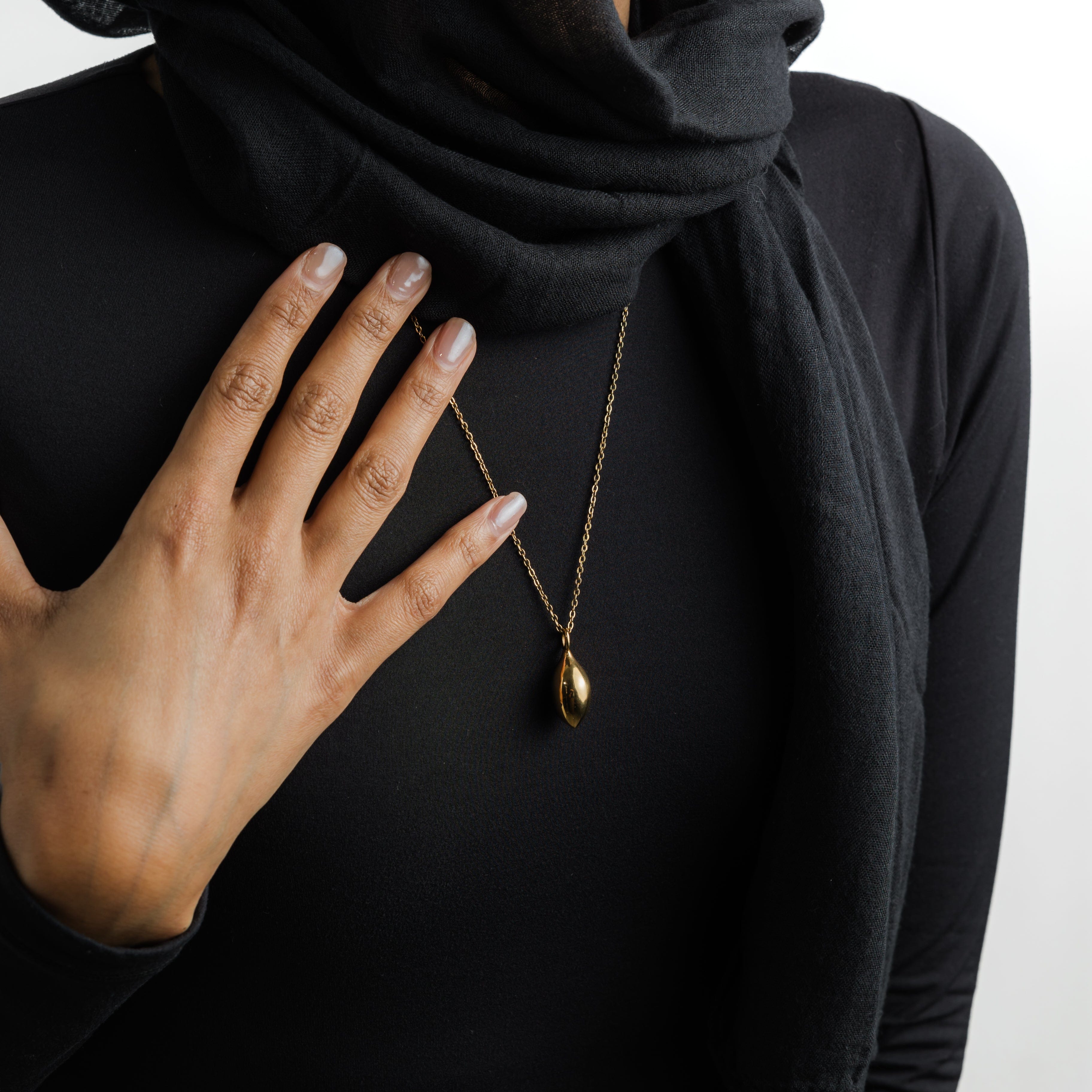 Close-up of the olive necklace showcasing its beautiful design and gold plating.